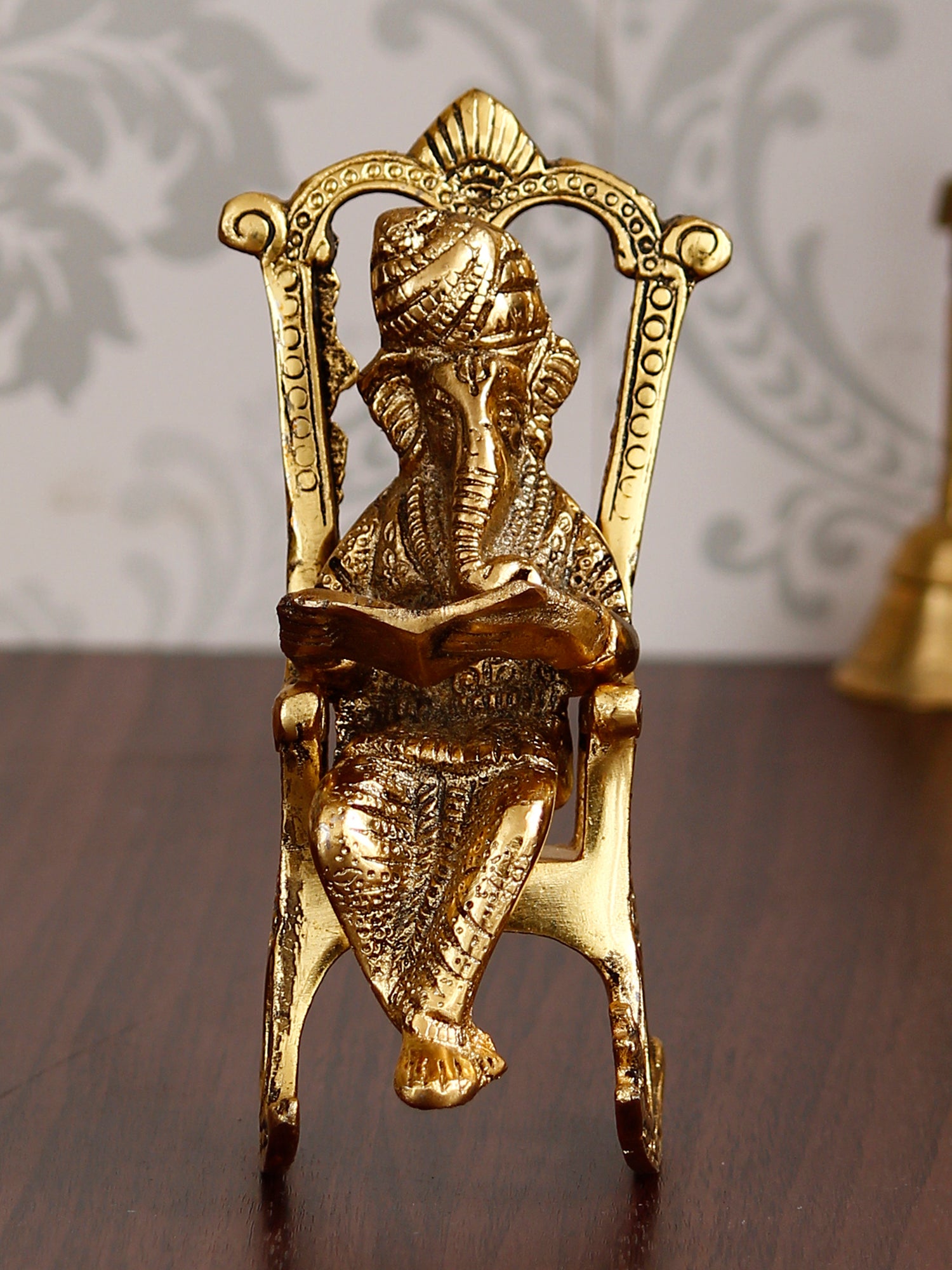 Golden Metal Lord Ganesha Idol Reading Book on Rocking Chair