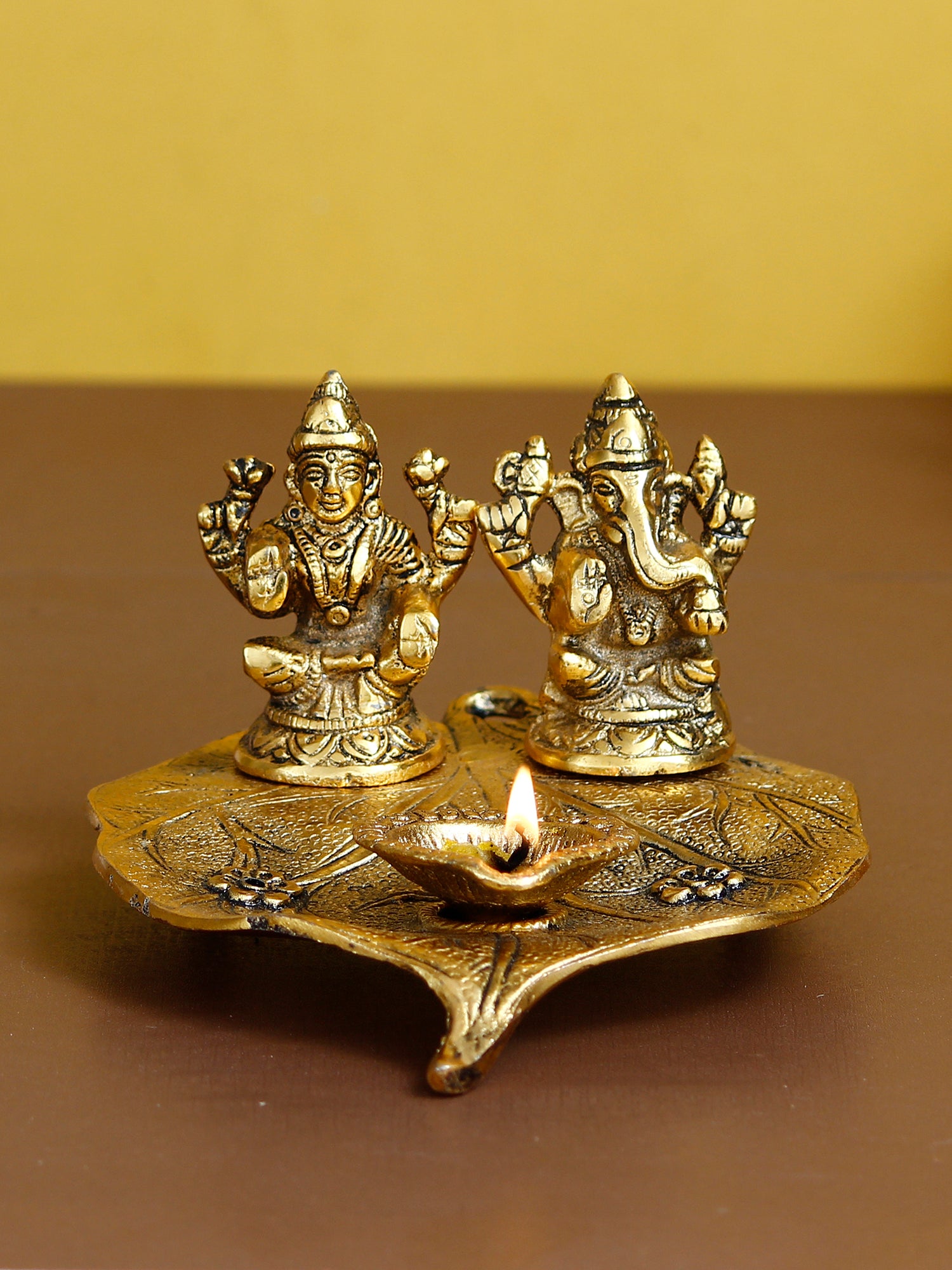 Golden Metal Handcrafted Laxmi Ganesha Idols with Diya on Leaf