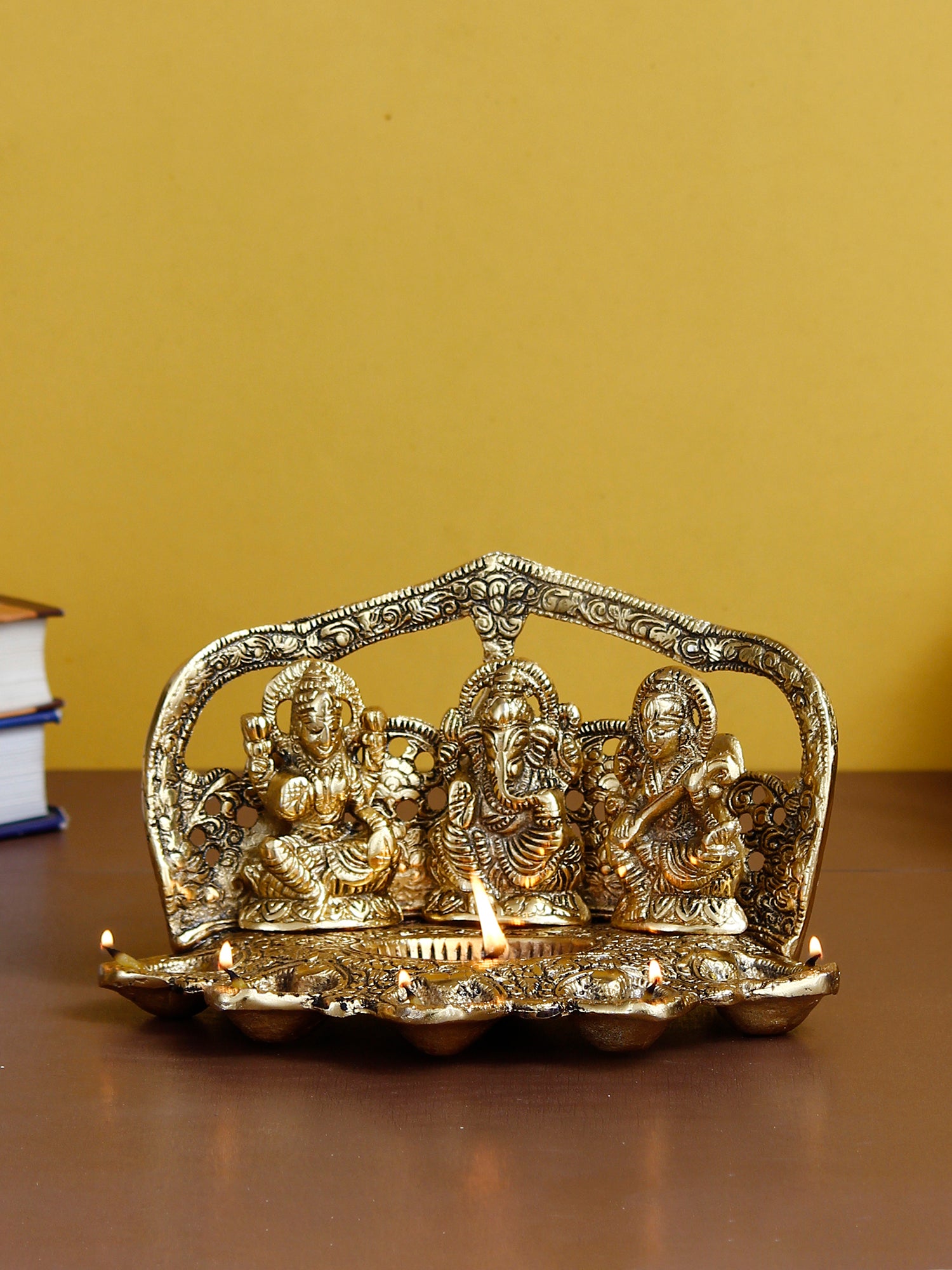 Golden Metal Handcrafted Laxmi Ganesha Saraswati Idols with Diya for 6 Wicks 1