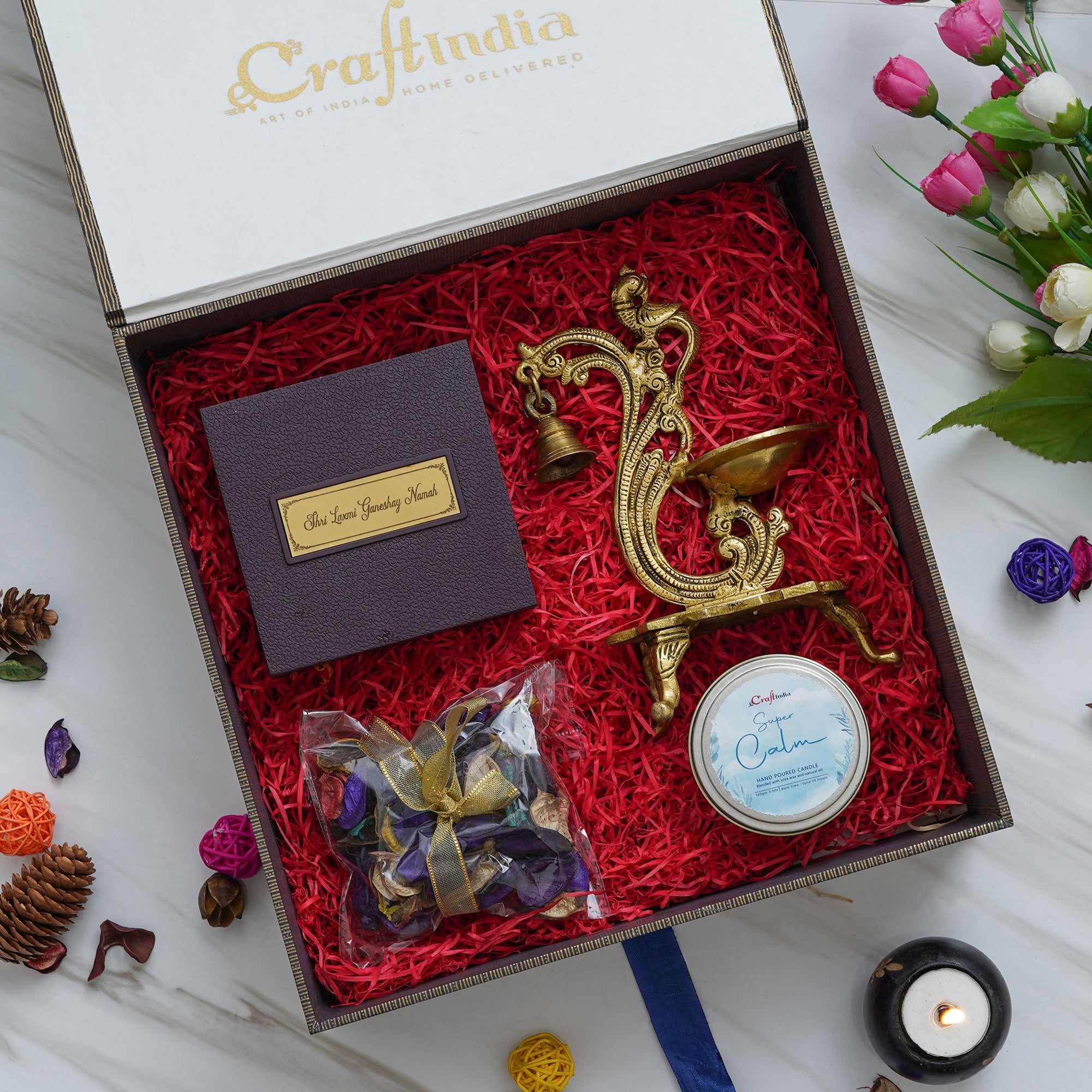 eCraftIndia Gift A Greet Hamper - Golden Handcrafted Parrot Designer Brass Diya with Bells and Stand, Gold Plated Lakshmi Ganesha Photo Frame and Charan Paduka Pooja Box, Super Calm Hand Poured Soya Wax Candle, Potpourri