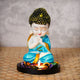 ecraftindia-praying-blue-monk-buddha-with-wooden-base-fragranced-petals-and-tealight-1