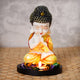 ecraftindia-praying-orange-monk-buddha-with-wooden-base-fragranced-petals-and-tealight-1