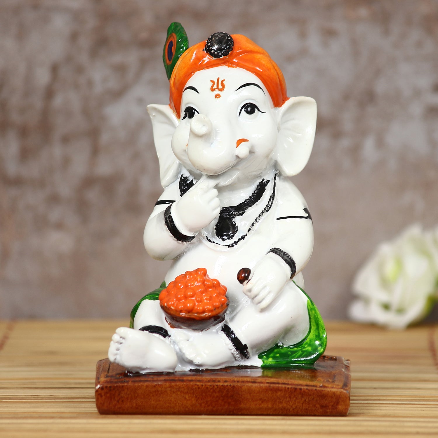 Decorative Polyresin Lord Ganesha Idol eating Ladoo in Lord Krishna Avatar (White, Orange, Green) 1