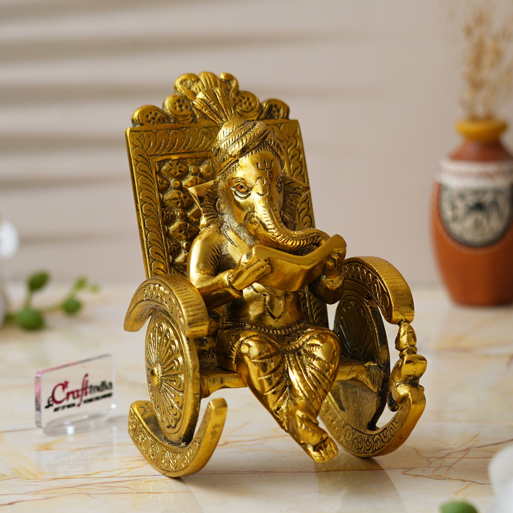 Golden Metal Handcrafted Lord Ganesha Idol Reading Book on Rocking Chair 1