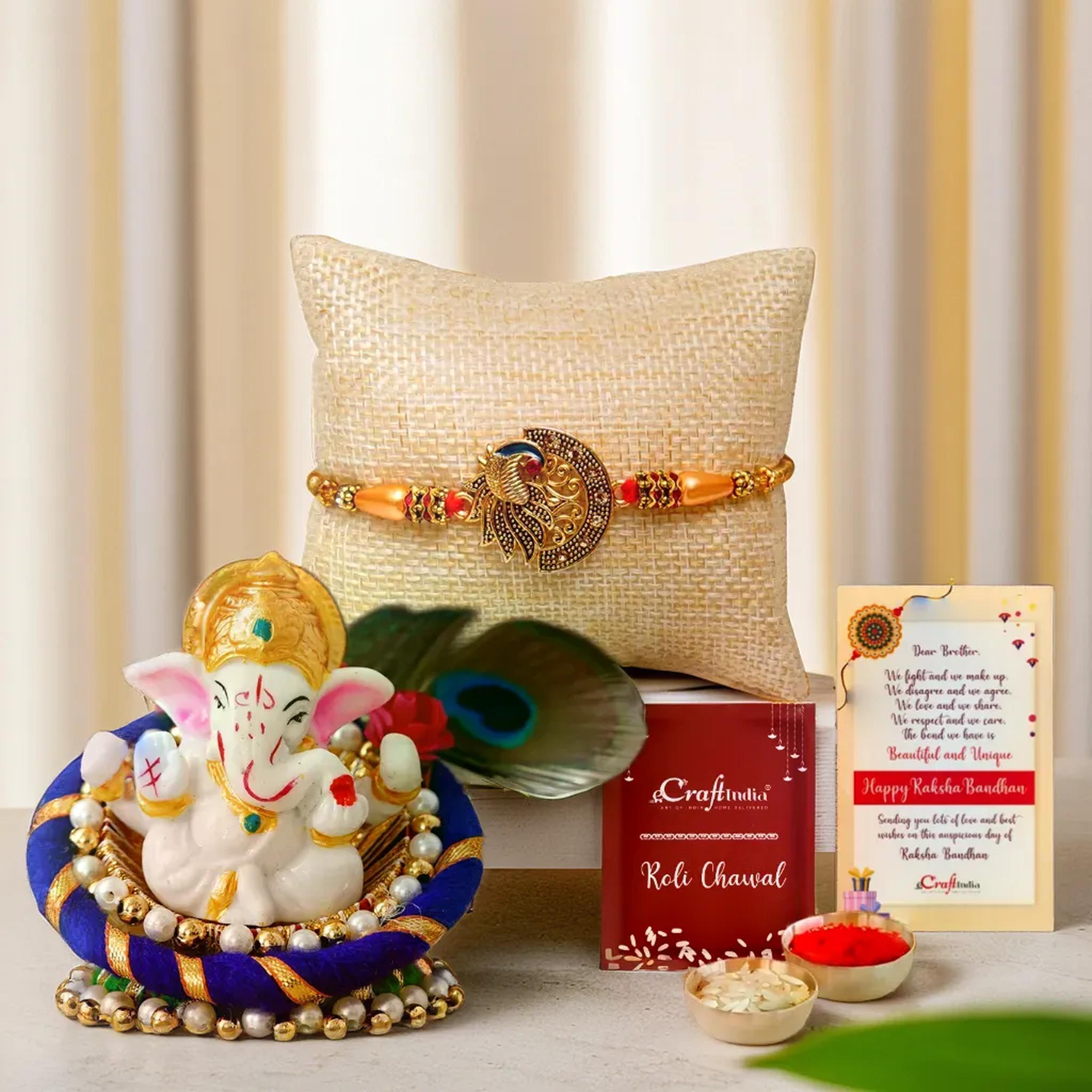 eCraftIndia Peacock Designer Rakhi for Brother with Lord Ganesha Idol on Decorative Floral Plate and Roli Chawal Pack