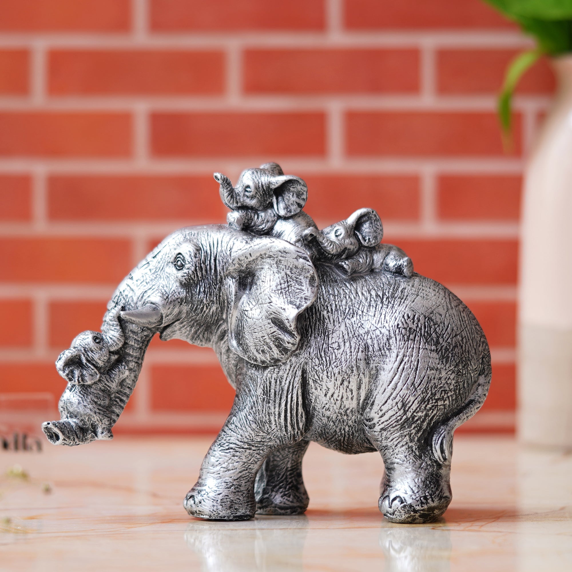 Cute Silver Elephant Statue Carries Three Calves on Its Back and Trunk 1