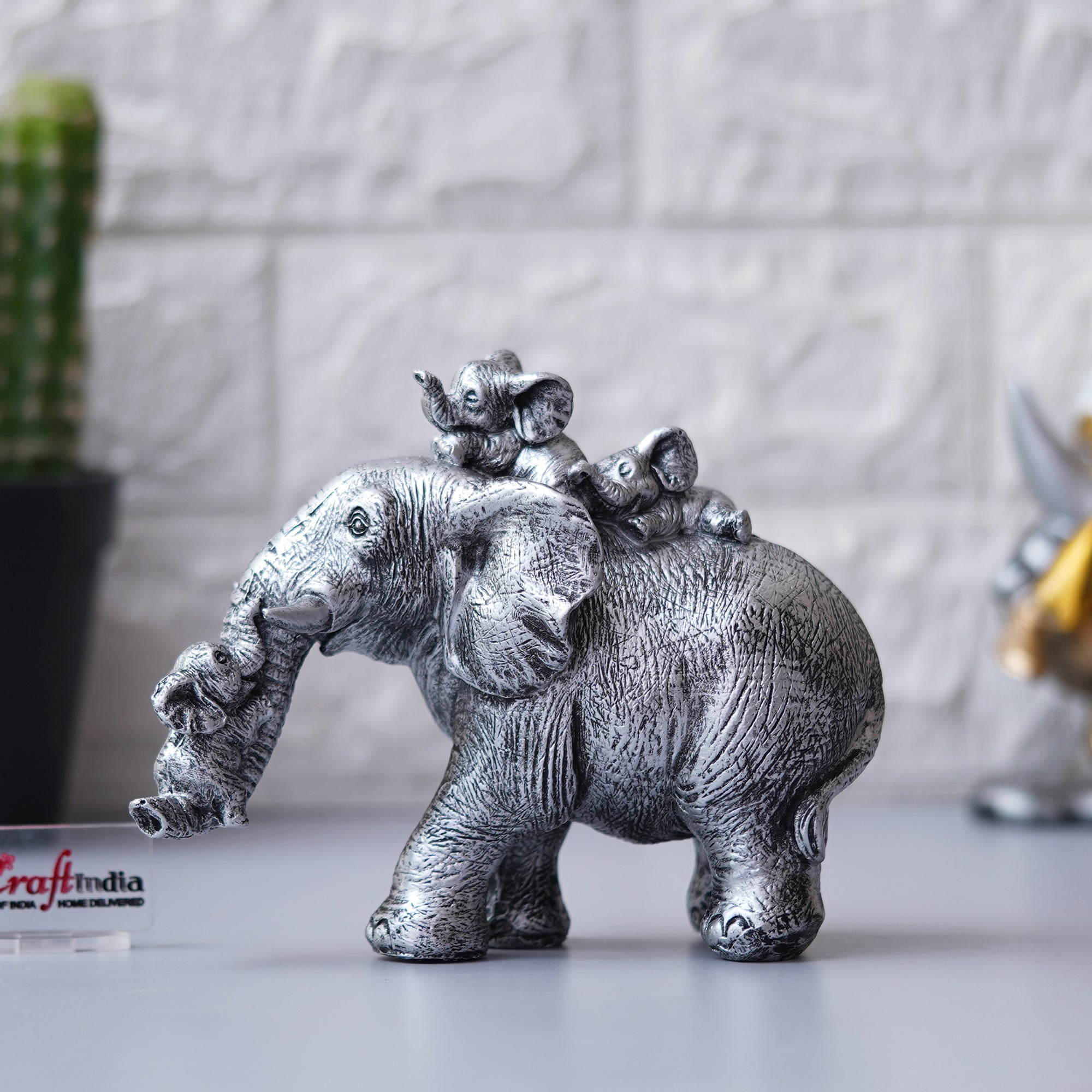 Cute Silver Elephant Statue Carries Three Calves on Its Back and Trunk