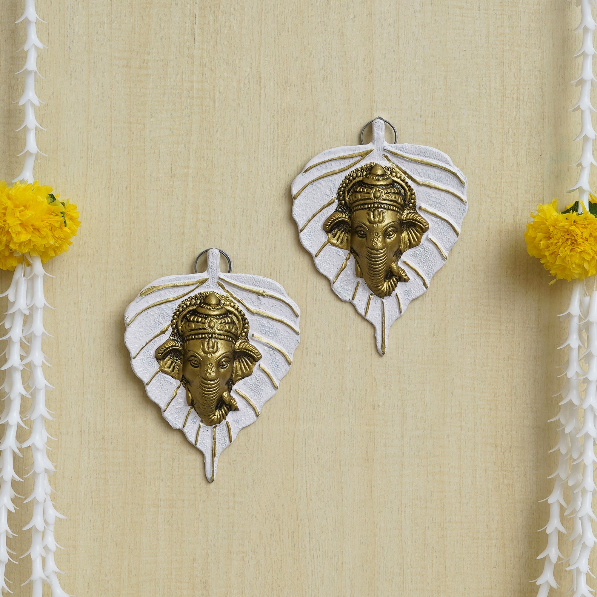eCraftIndia Set of 2 Golden and White Peepal Leaf Ganesha Wall Hangings 1