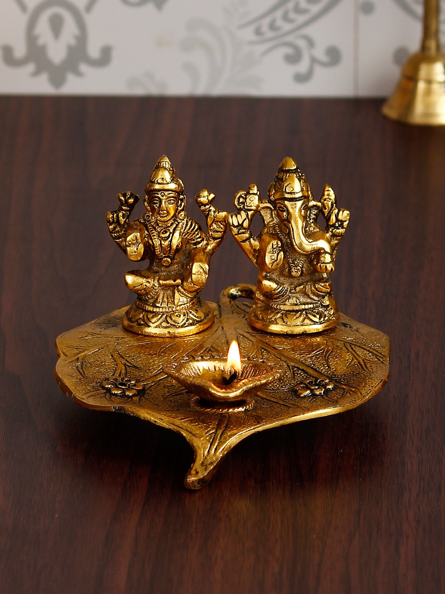 Golden Metal Handcrafted Laxmi Ganesha Idols with Diya on Leaf 1
