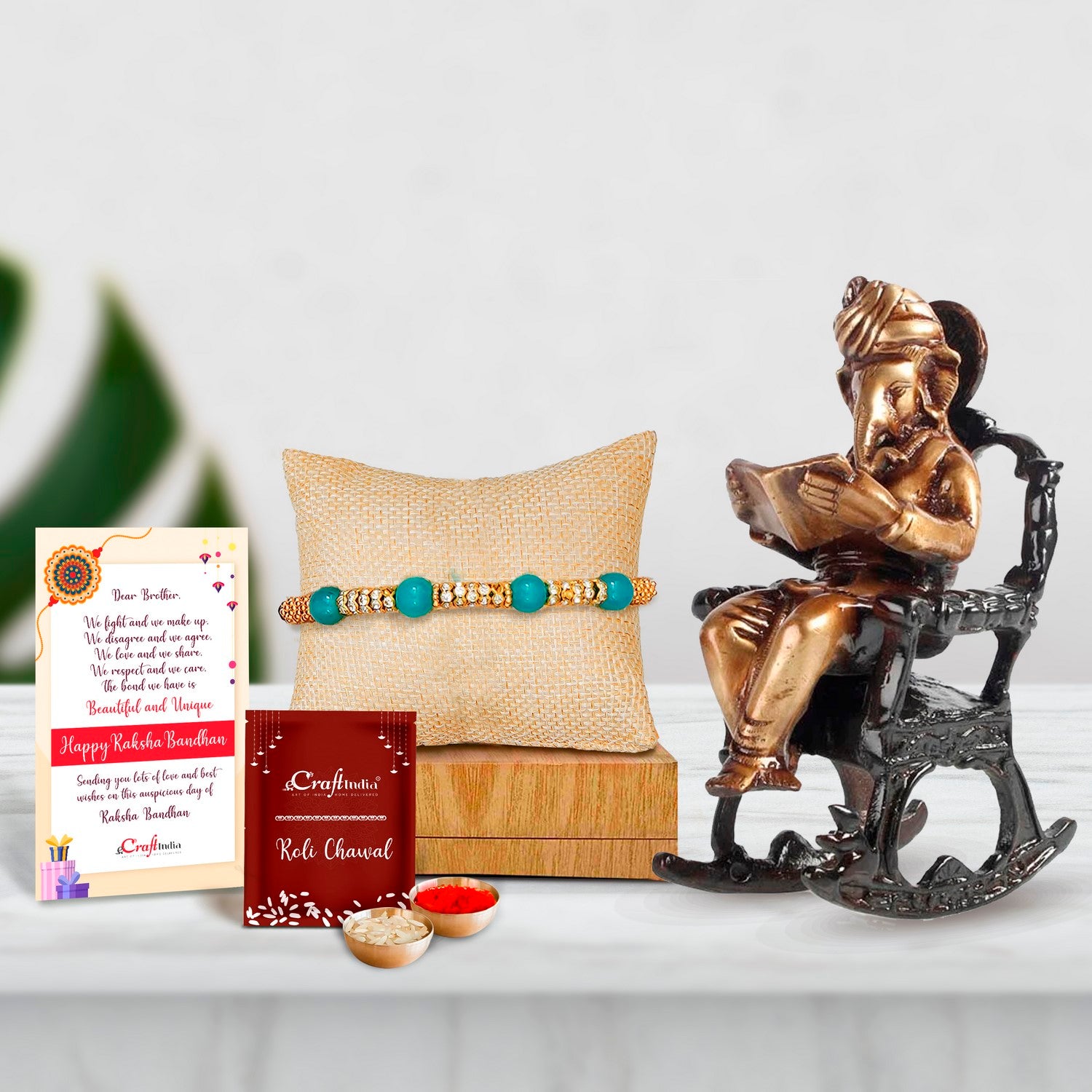 Designer Pearl Rakhi with Brass Lord Ganesha on Rocking Chair Antique Showpiece and Roli Chawal Pack, Best Wishes Greeting Card
