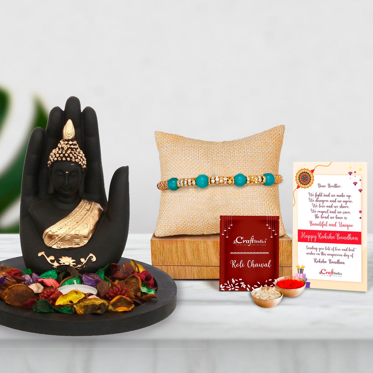 Designer Pearl Rakhi with Golden Handcrafted Palm Buddha Decorative Showpiece with Wooden Base, Fragranced Petals and Tealight and Roli Chawal Pack, Best Wishes Greeting Card