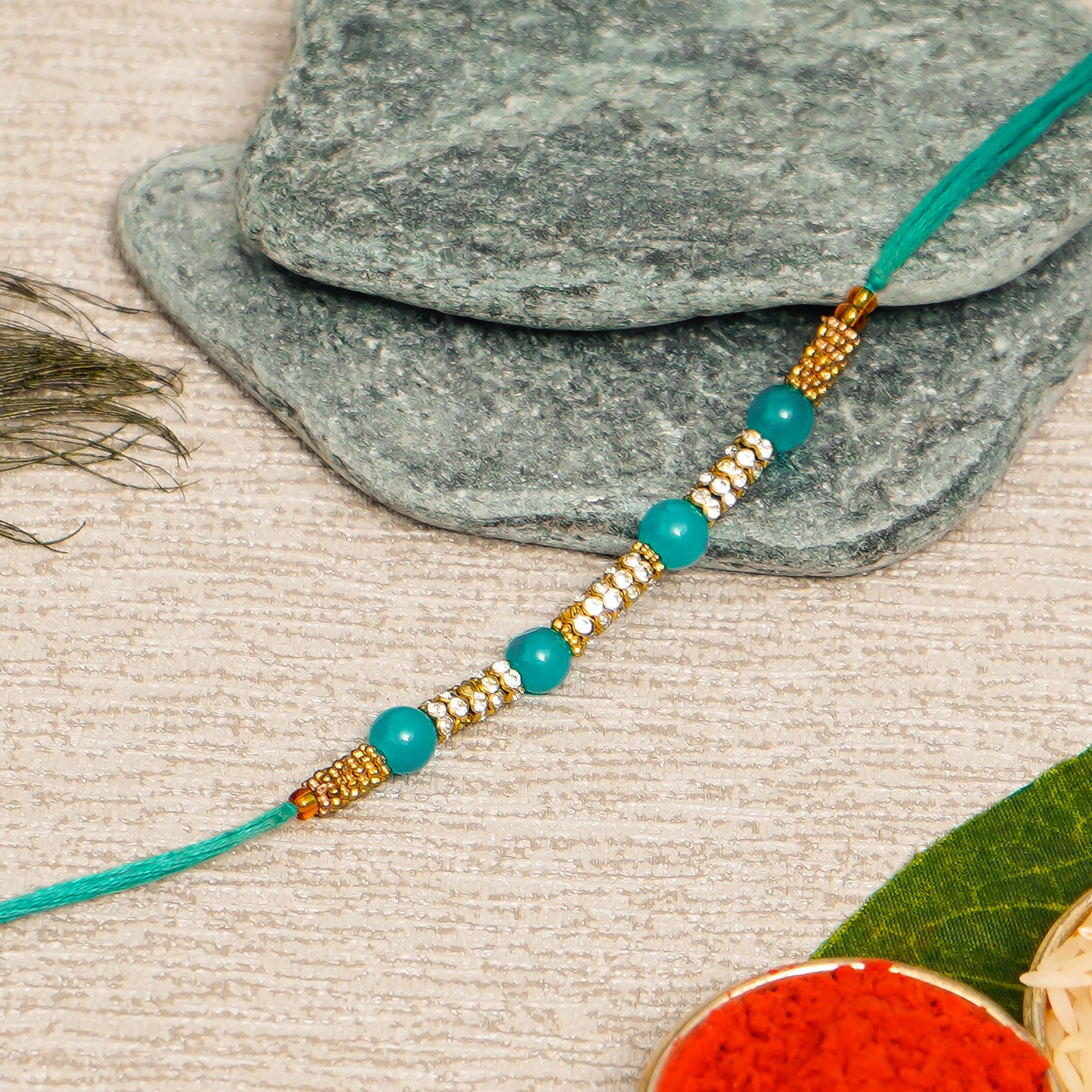 Designer Pearl Rakhi with Decorative Brass Figurine  and Roli Chawal Pack, Best Wishes Greeting Card 1