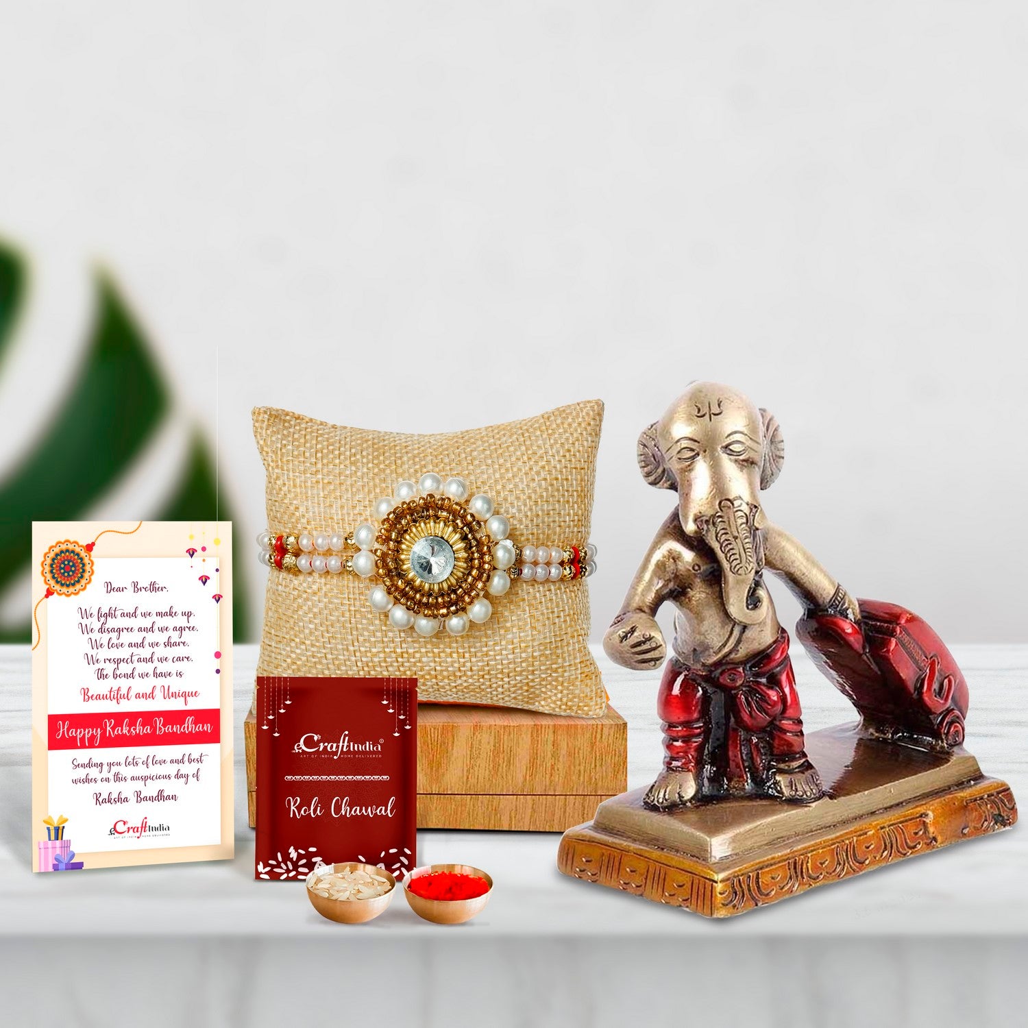 Designer Handcrafted Stone Pearl Rakhi with Brass Ganesha Carrying Happiness around the world Antique Showpiece and Roli Chawal Pack, Best Wishes Greeting Card