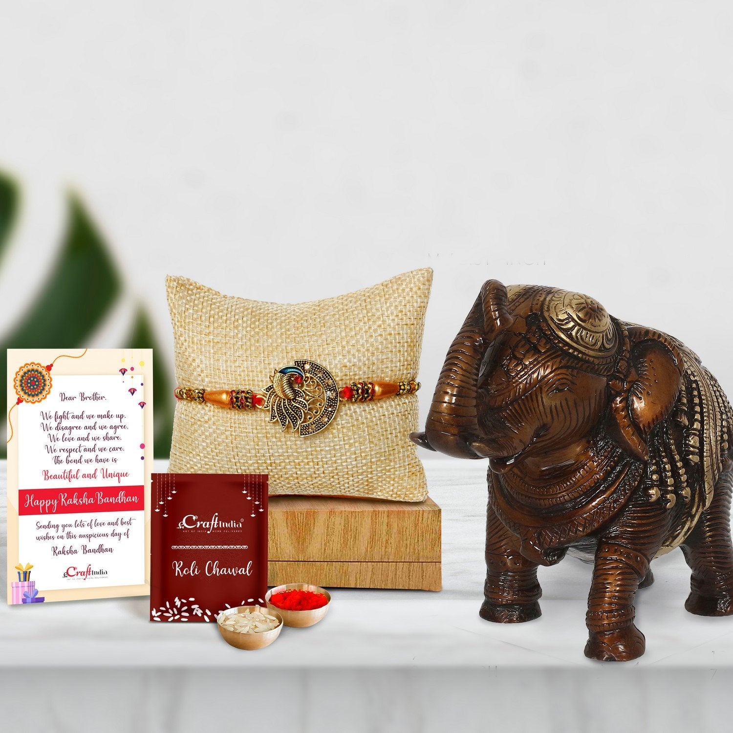 Designer Peacock Rakhi with Antique Finish Decorative Brass Elephant Fingurine and Roli Chawal Pack, Best Wishes Greeting Card