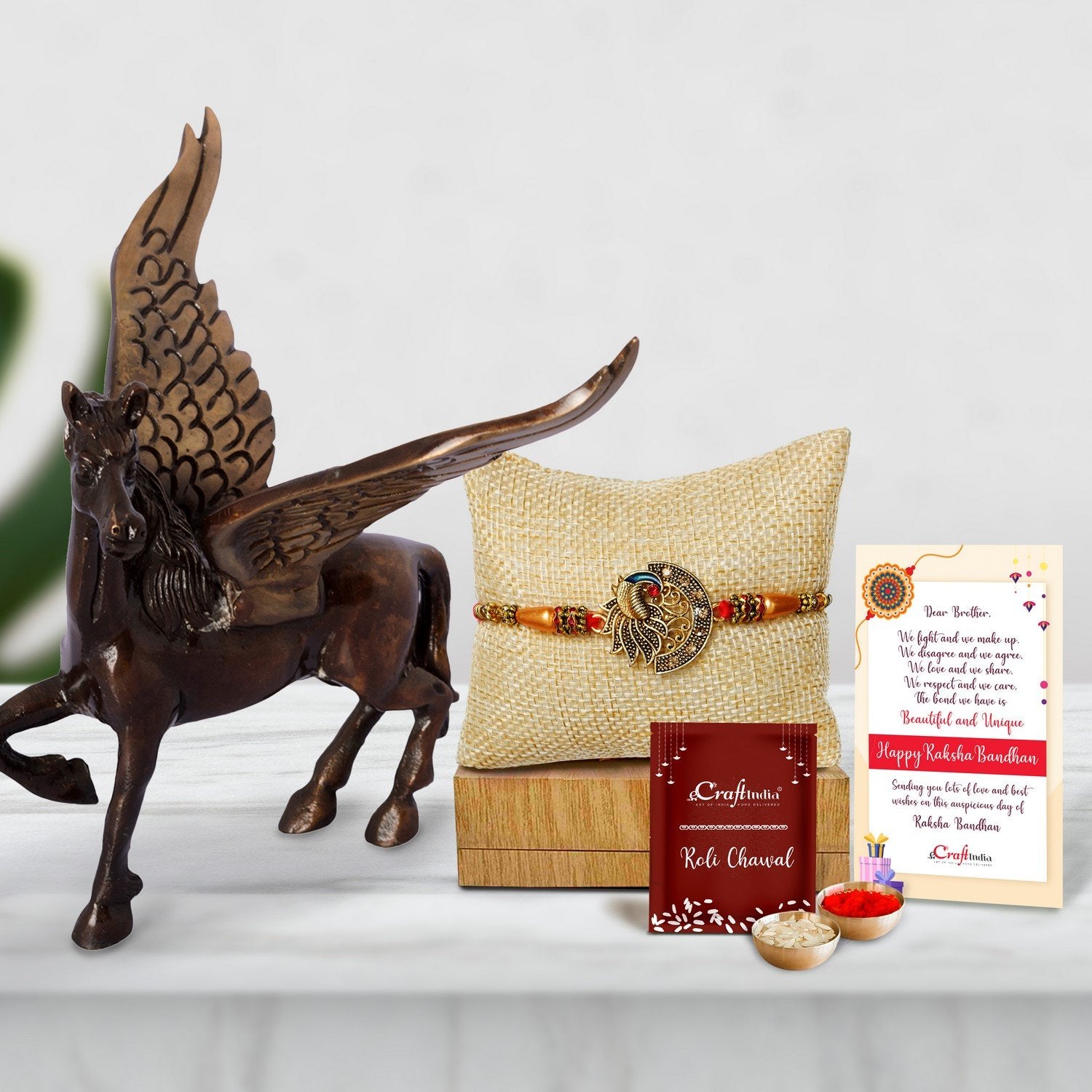 Designer Peacock Rakhi with Brass Antique Finish Flying Angel Horse and Roli Chawal Pack, Best Wishes Greeting Card