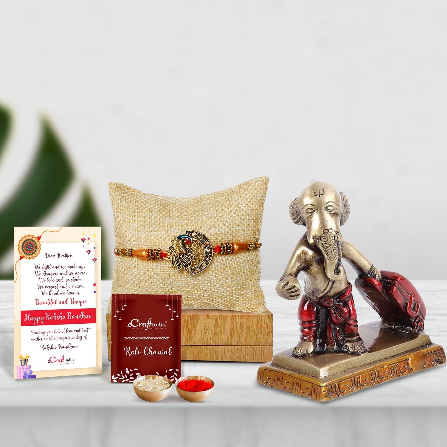 Designer Peacock Rakhi with Brass Ganesha Carrying Happiness around the world Antique Showpiece and Roli Chawal Pack, Best Wishes Greeting Card