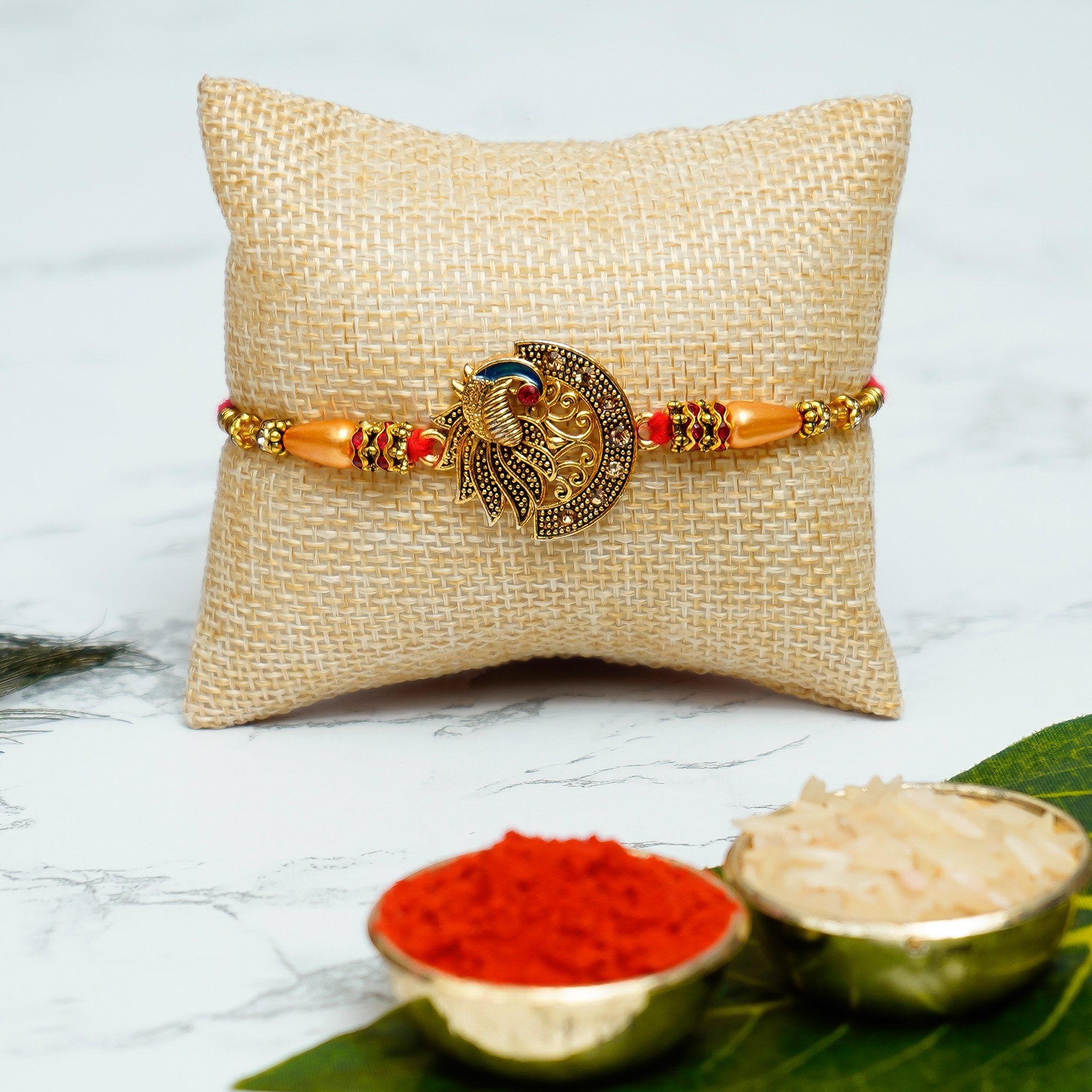 Designer Peacock Rakhi with Praying Red Monk Buddha with Wooden Base, Fragranced Petals and Tealight and Roli Chawal Pack, Best Wishes Greeting Card 1