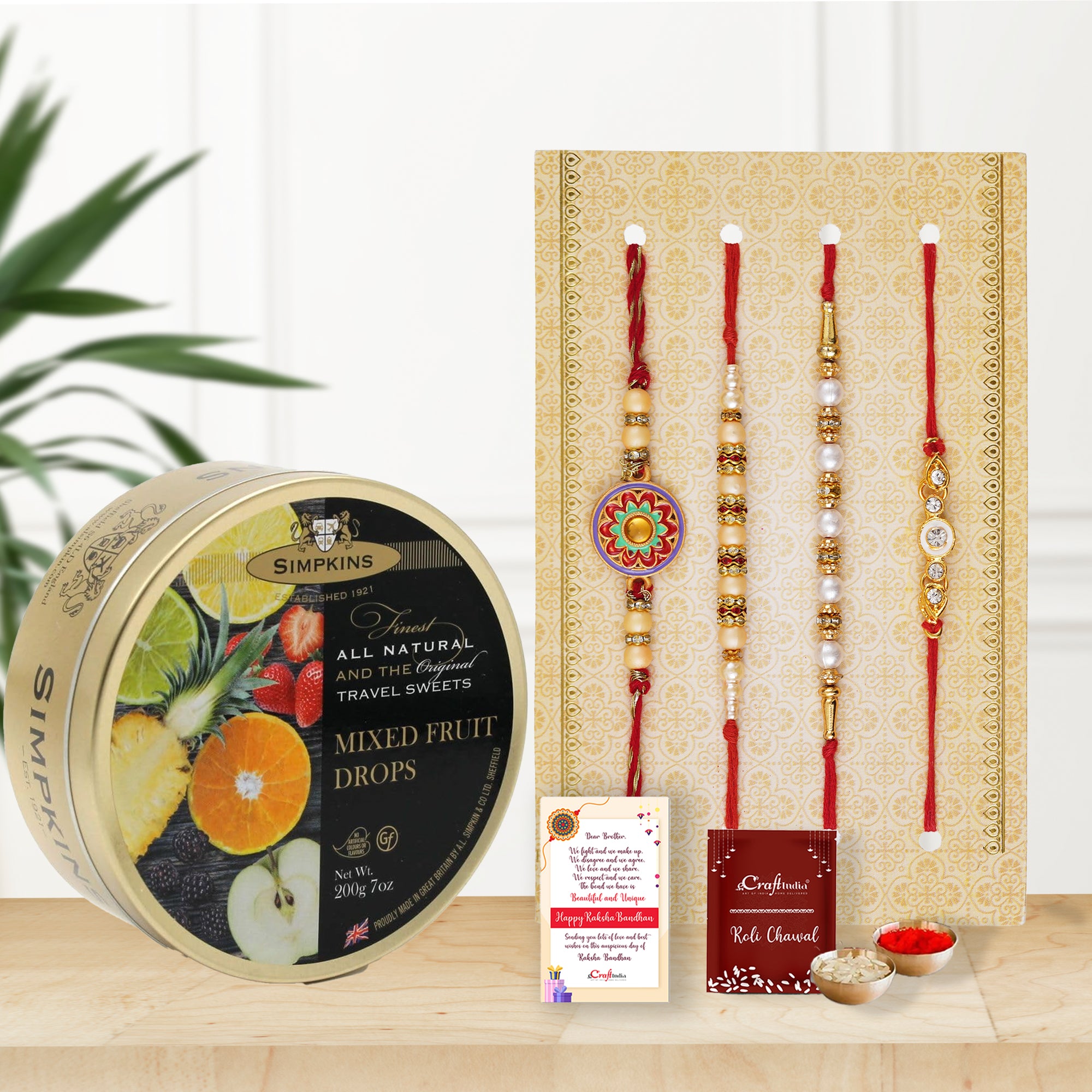 Set of 4 Designer Pearl Rakhis, Roli Chawal Pack, Raksha Bandhan Greeting Card, and Simpkins Mixed Fruit Drops Candy