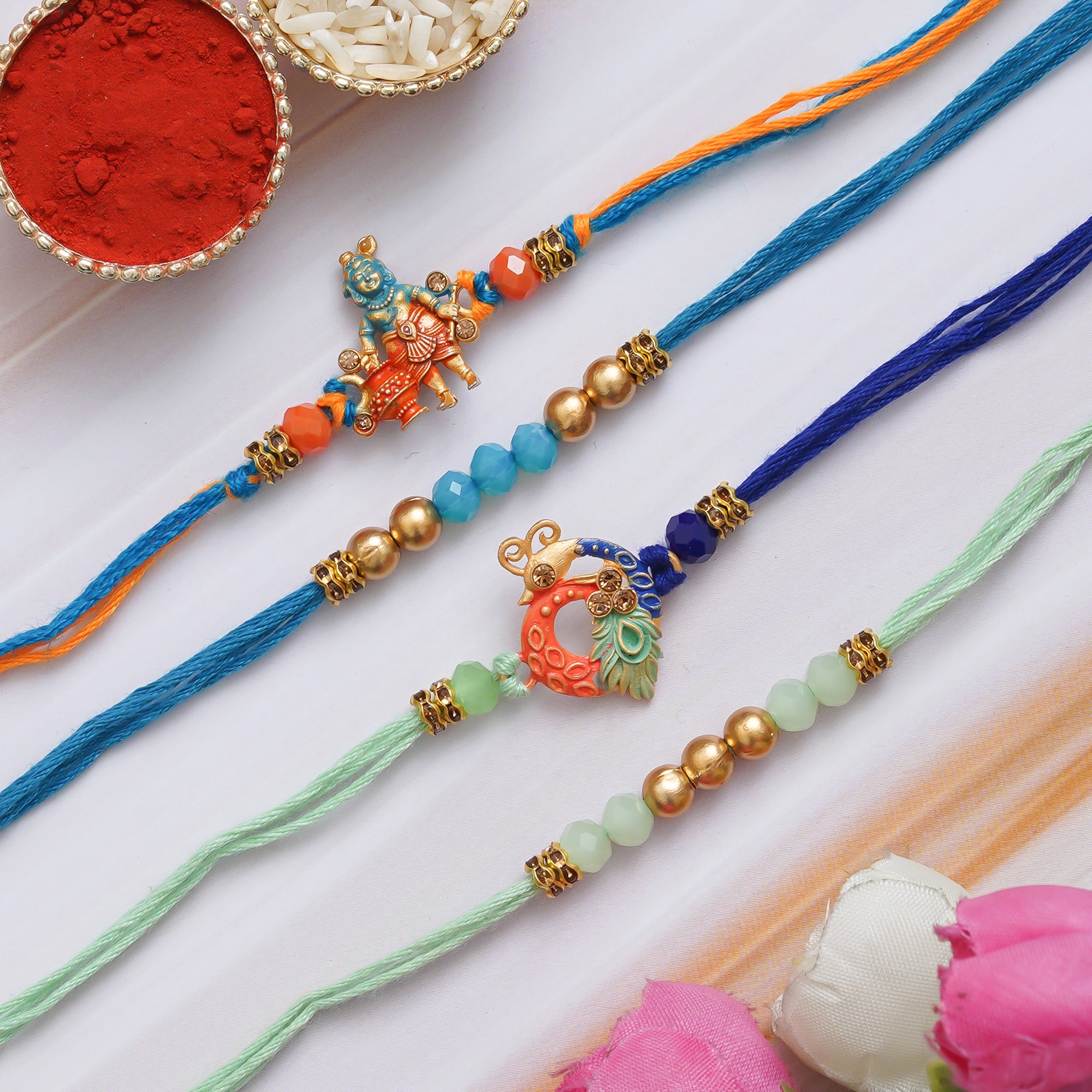 eCraftIndia Multicolor Set of 4 Lord Krishna, Peacock, Beads, Pearls Religious Designer Rakhis with Roli Chawal Pack