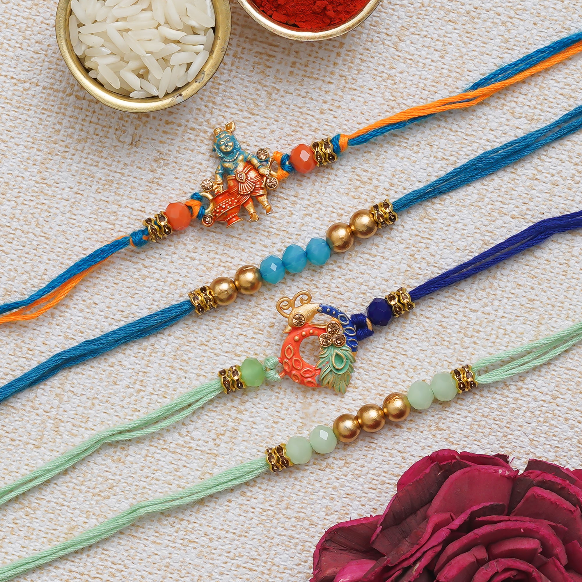 eCraftIndia Multicolor Set of 4 Lord Krishna, Peacock, Beads, Pearls Religious Designer Rakhis with Roli Chawal Pack 1