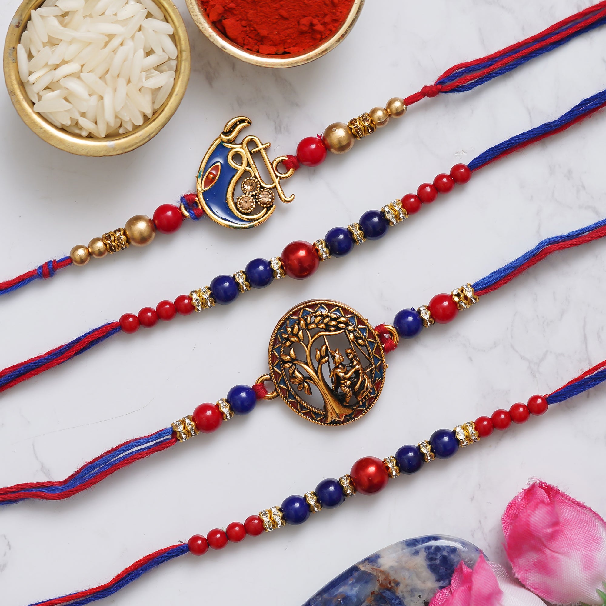 eCraftIndia Set of 4 Multicolor Shri Ganesha, Radha Krishna, Pearls Religious Designer Rakhis with Roli Chawal Pack