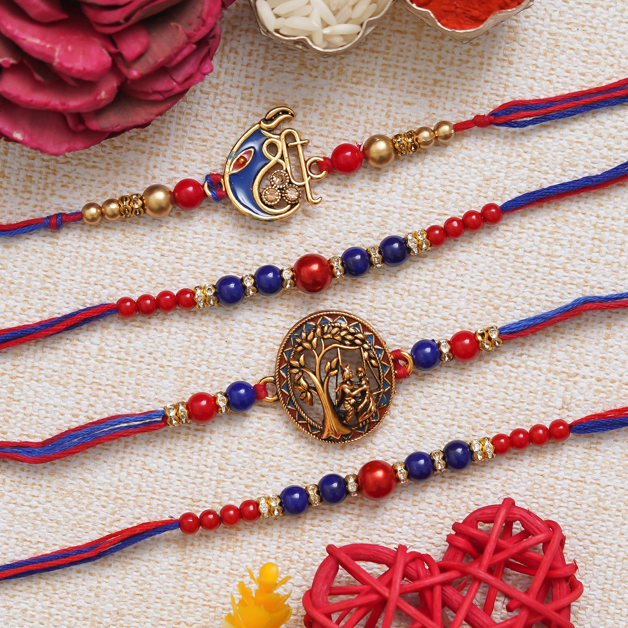 eCraftIndia Set of 4 Multicolor Shri Ganesha, Radha Krishna, Pearls Religious Designer Rakhis with Roli Chawal Pack 1