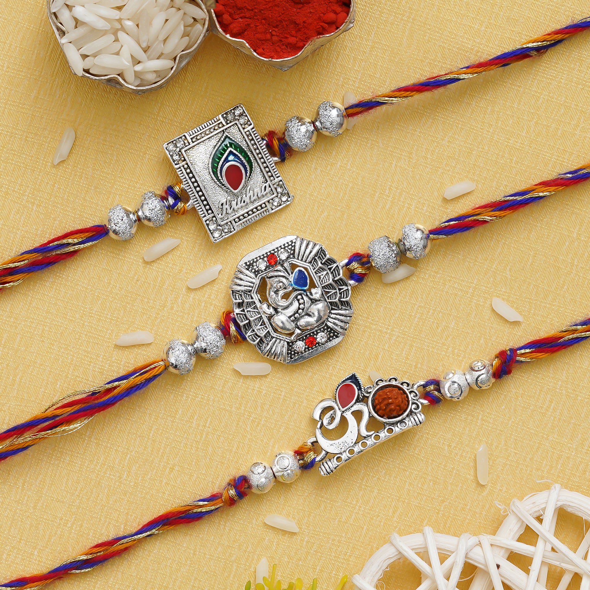 Set of 3 Om, Krishna with Peacock Feather, Lord Ganesha Silver Religious Designer Rakhis with Roli Chawal Pack 1