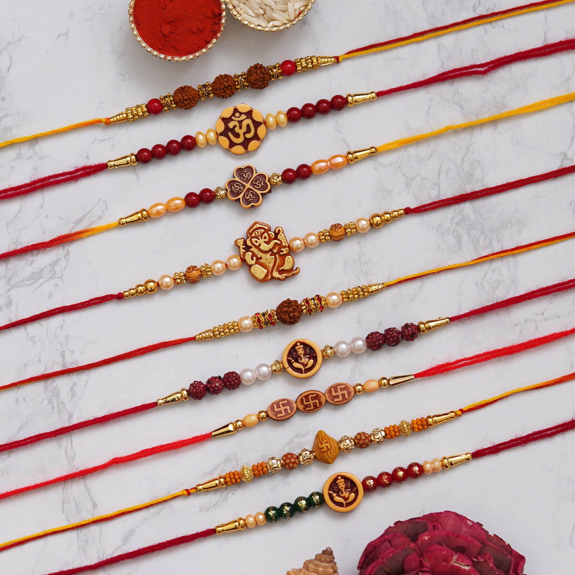eCraftIndia Multicolor Set of 9 Om, Ganesha, Swastik, Rudraksha, Pearls Religious Designer Rakhis with Roli Chawal Pack 1