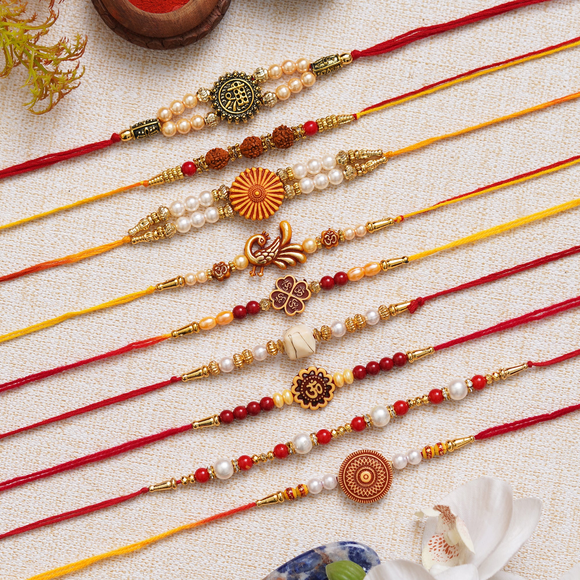 eCraftIndia Set of 9 Shri, Rudraksha, Flower, Peacock, Om, Beads, Pearl Religious Designer Rakhis with Roli Chawal Pack
