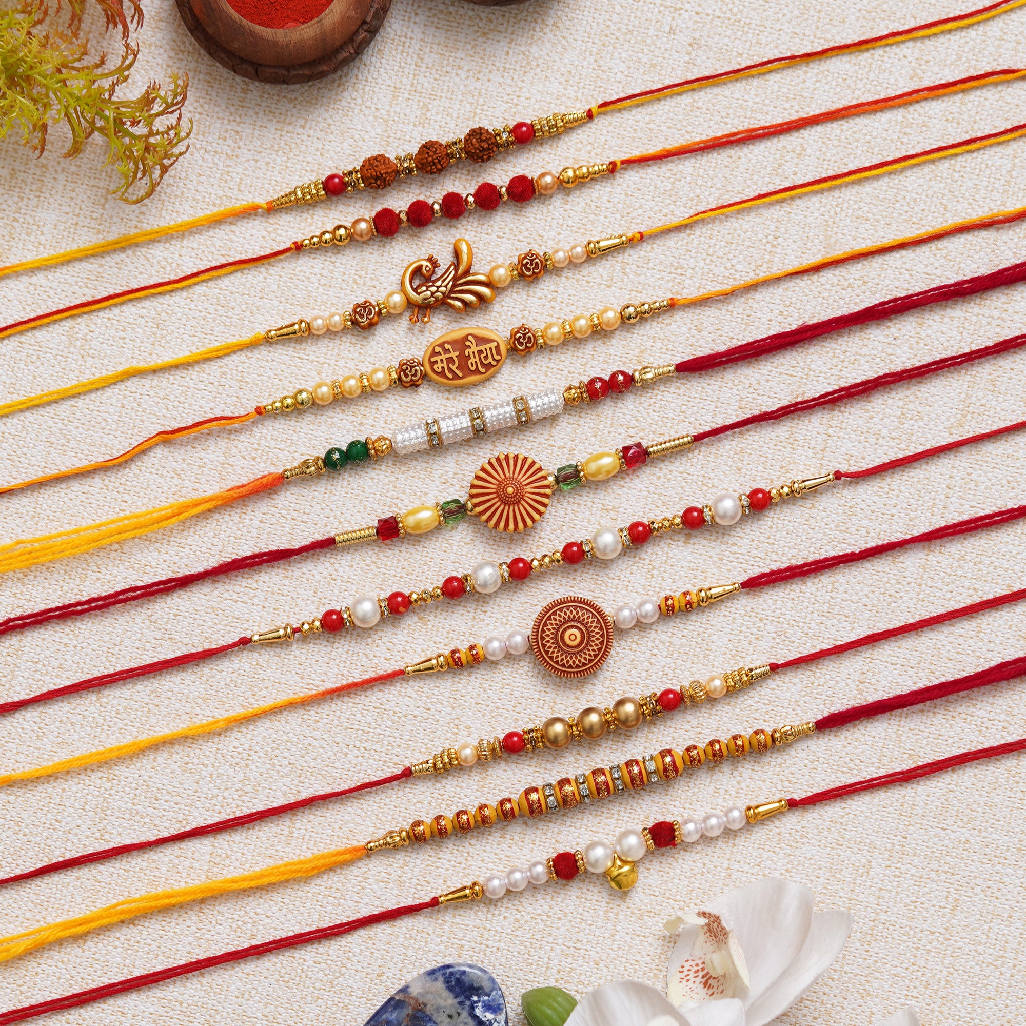 eCraftIndia Set of 11 Rudraksha, Peacock, Mere Bhaiya, Flower, Beads, Pearls Designer Rakhis with Roli Chawal Pack
