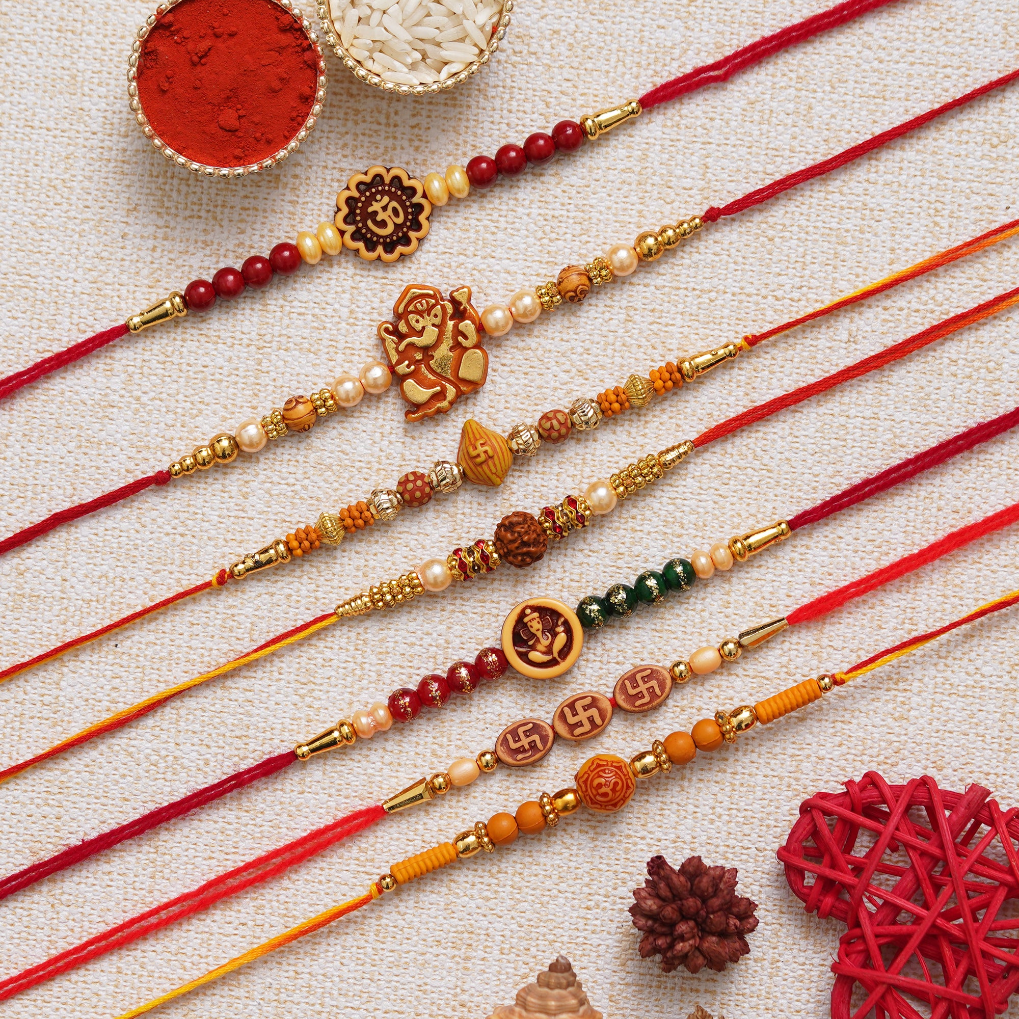 eCraftIndia Multicolor Set of 7 Om, Ganesha, Swastik, Rudraksha, Pearls Religious Designer Rakhis with Roli Chawal Pack