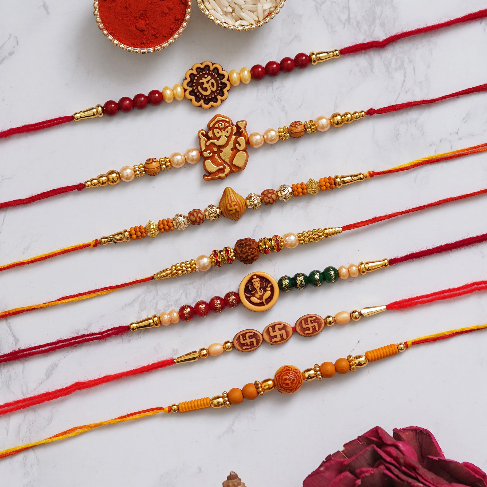 eCraftIndia Multicolor Set of 7 Om, Ganesha, Swastik, Rudraksha, Pearls Religious Designer Rakhis with Roli Chawal Pack 1