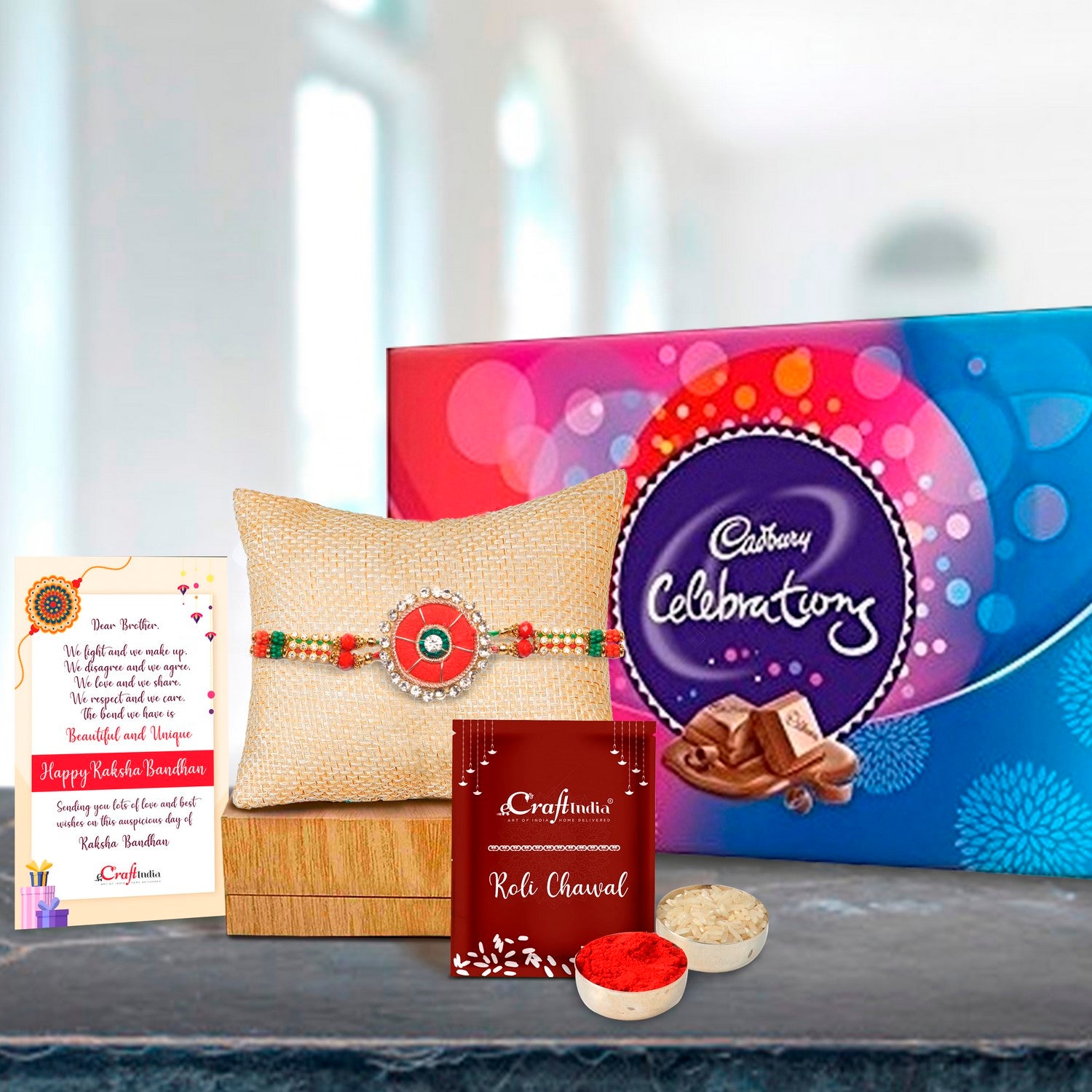 Designer Rakhi with Cadbury Celebrations Gift Pack of 7 Assorted Chocolates and Roli Chawal Pack, Best Wishes Greeting Card