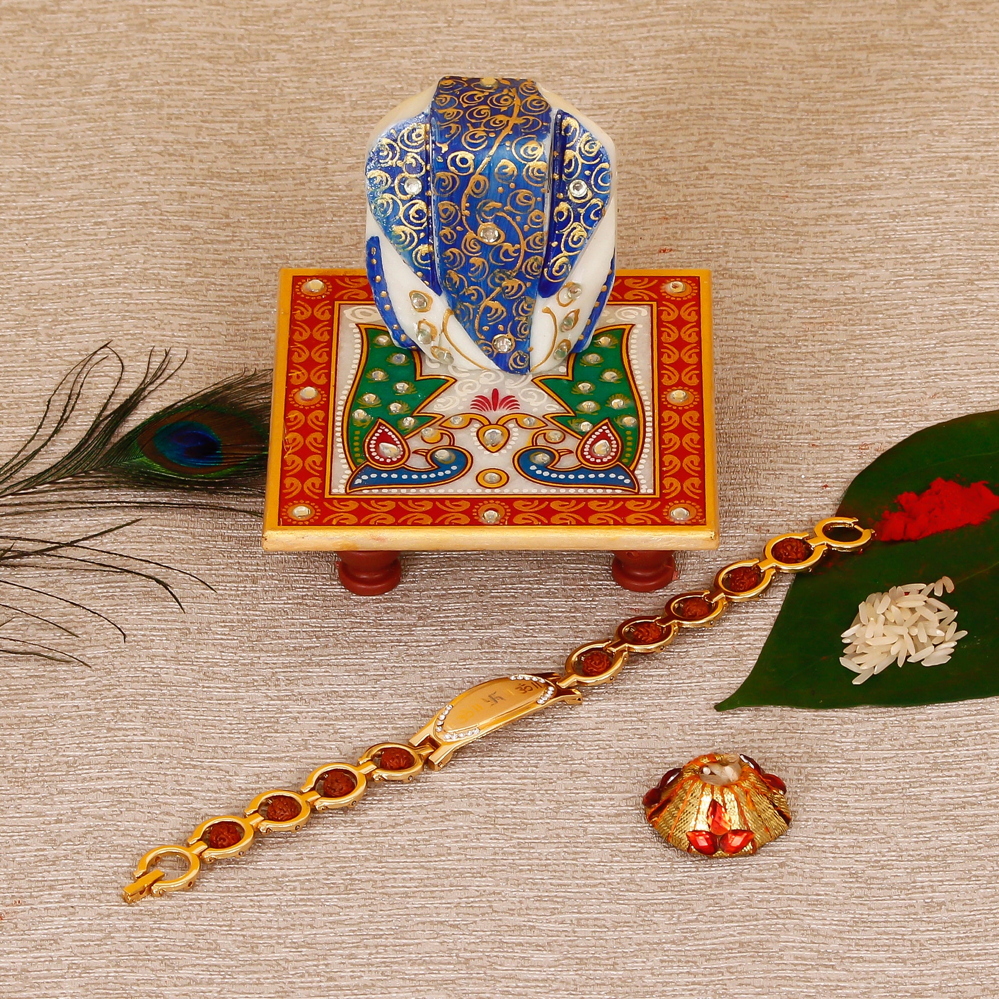 Designer Bracelet Religious Rakhi with Lord Ganesha on Marble Chowki and Roli Tikka Matki