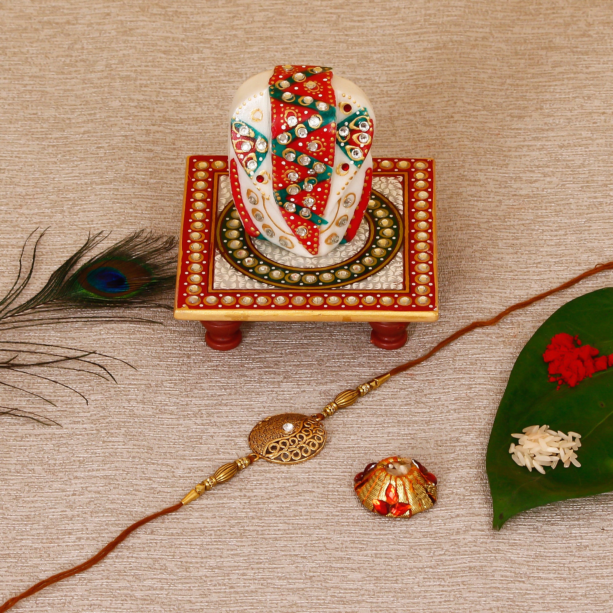 Designer Rakhi with Lord Ganesha on Kundan Studded Marble Chowki and Roli Tikka Matki