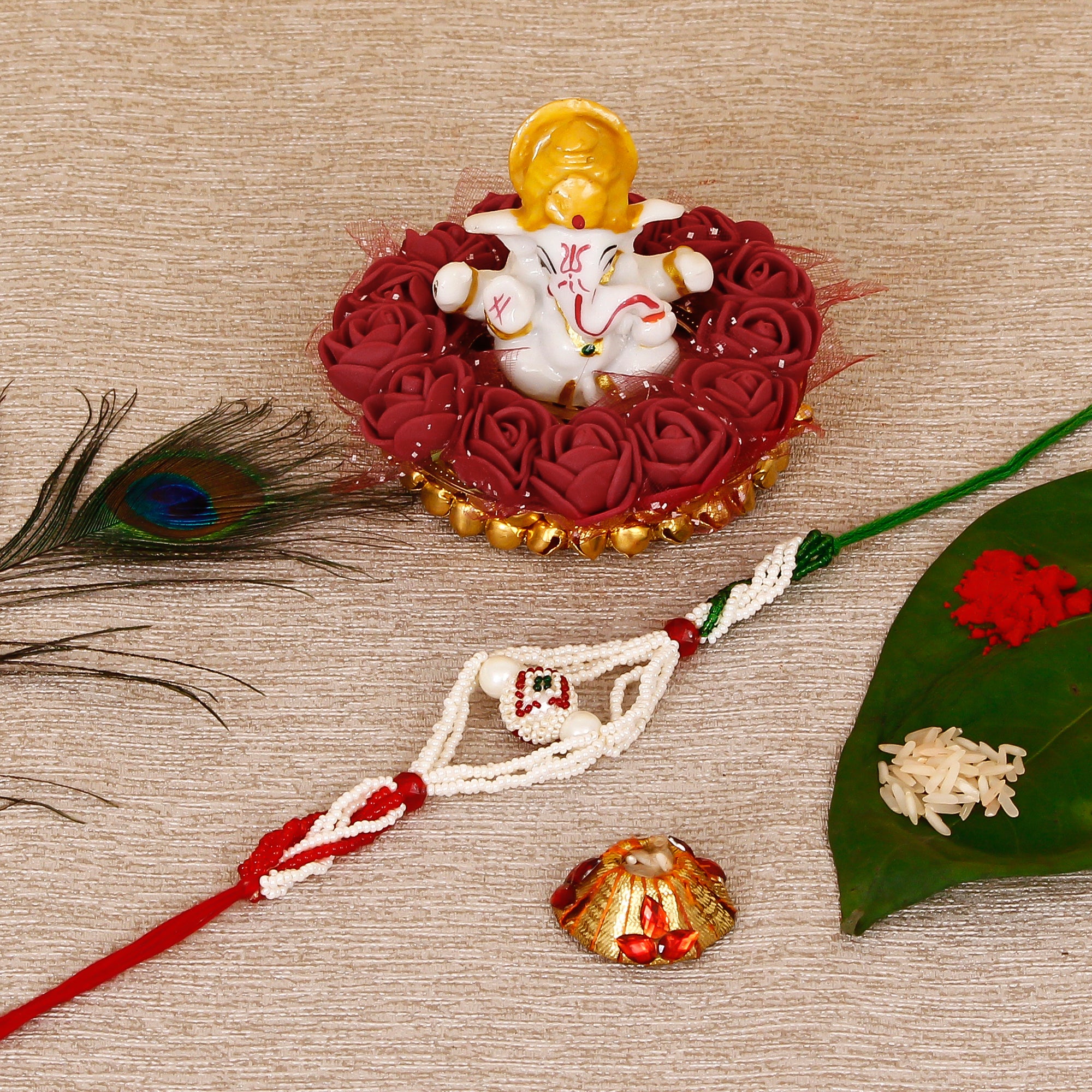 Designer Pearl Rakhi with Lord Ganesha Idol on Decorative Plate for Car & Home and Roli Tikka Matki