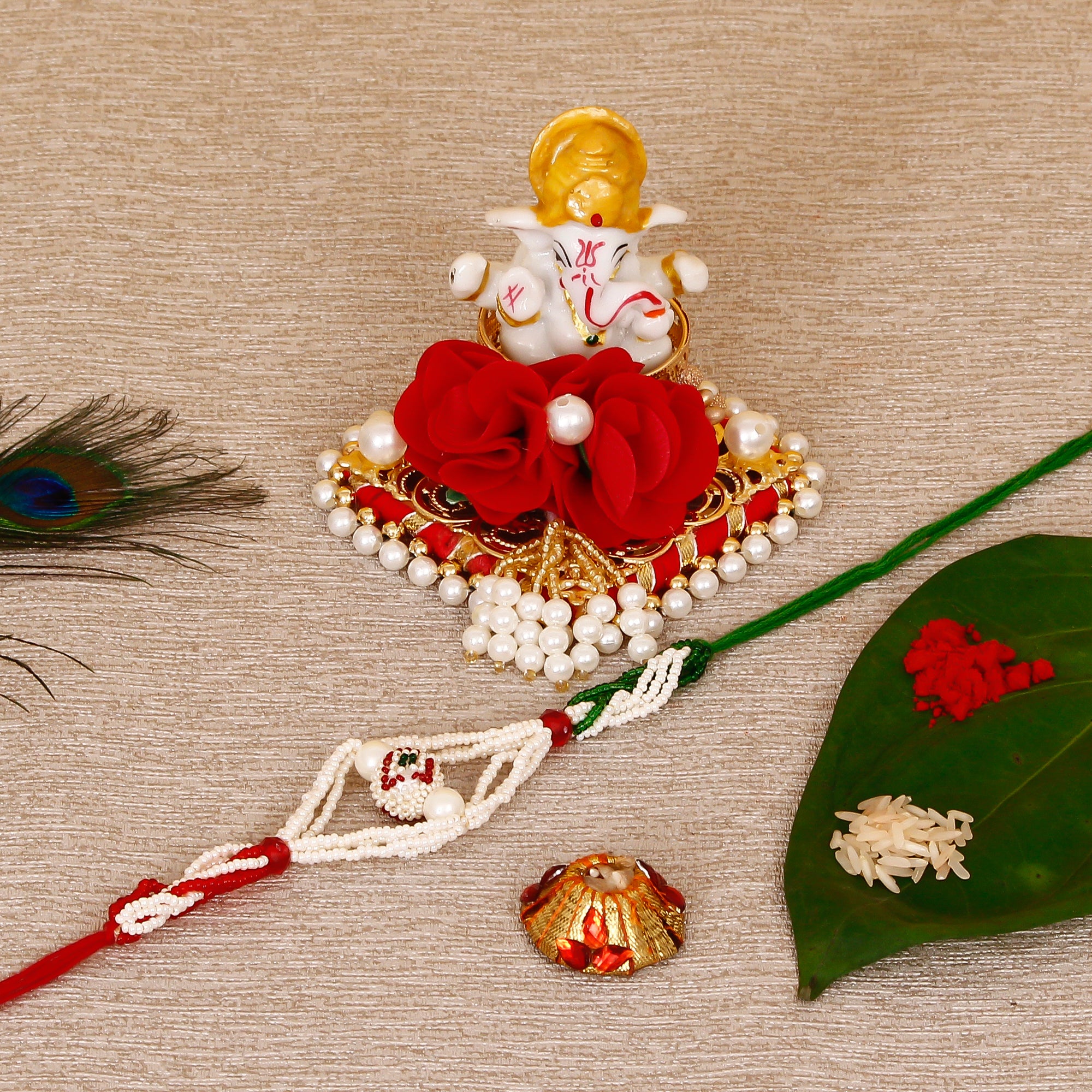Designer Pearl Rakhi with Lord Ganesha Idol on Decorative Plate for Car & Home and Roli Tikka Matki