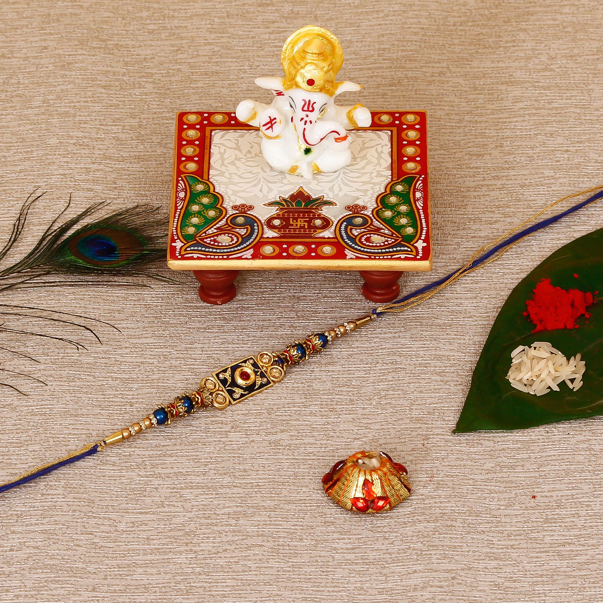 Designer Meenakari Rakhi with Lord Ganesha Marble Chowki and Roli Tikka Matki