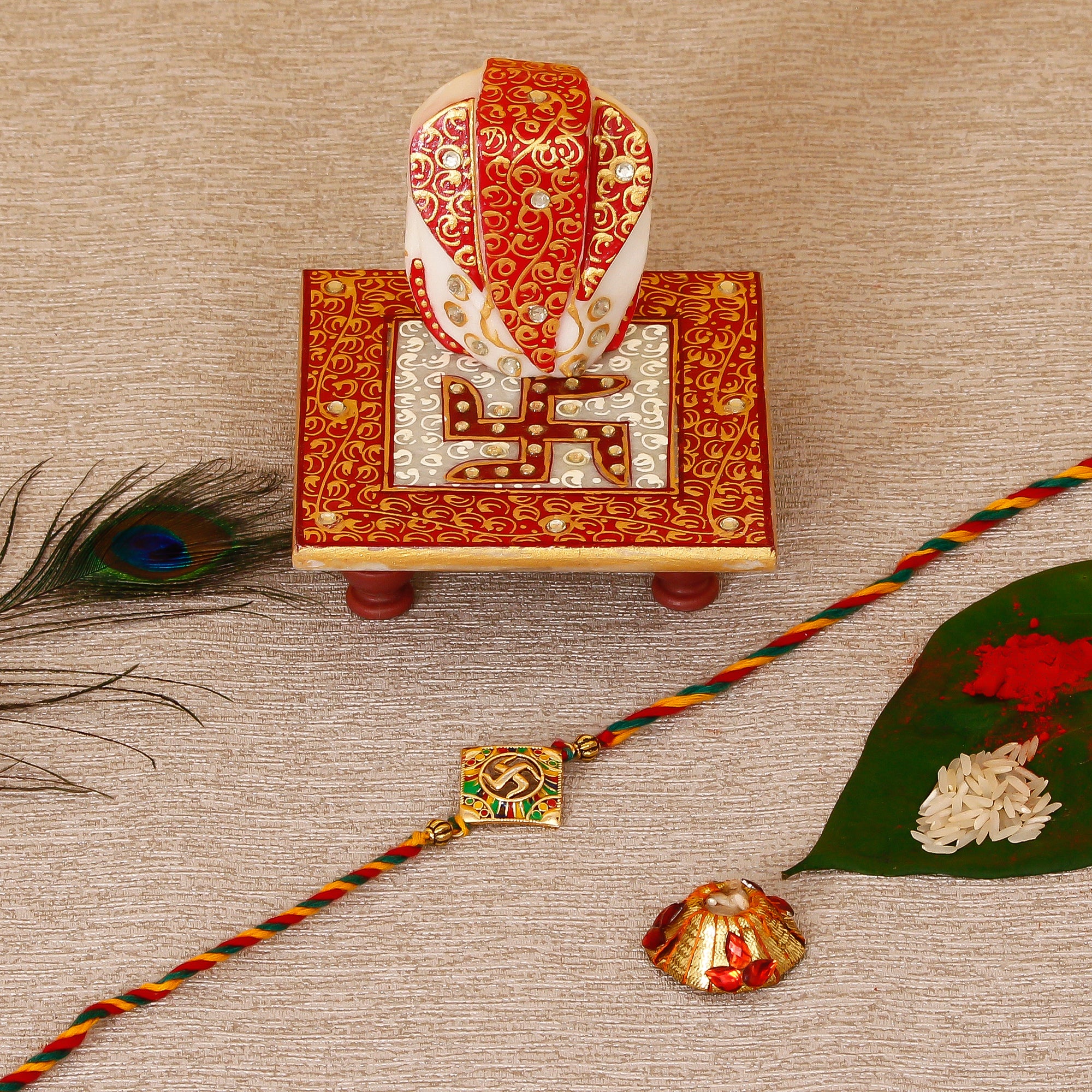 Designer Religious Swastik Rakhi with Ridhi Sidhi Marble chowki and Roli Tikka Matki