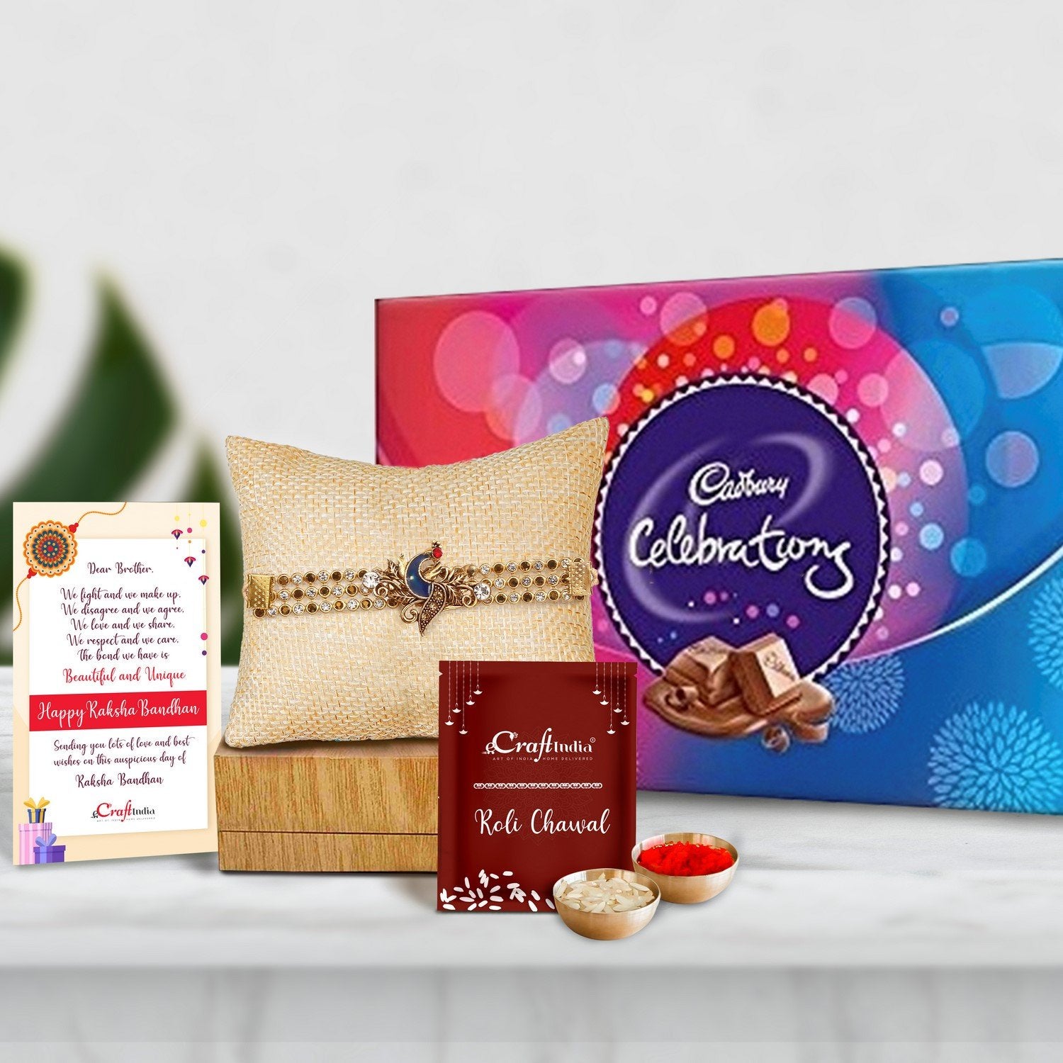 Designer Peacock Rakhi with Cadbury Celebrations Gift Pack of 7 Assorted Chocolates and Roli Chawal Pack, Best Wishes Greeting Card
