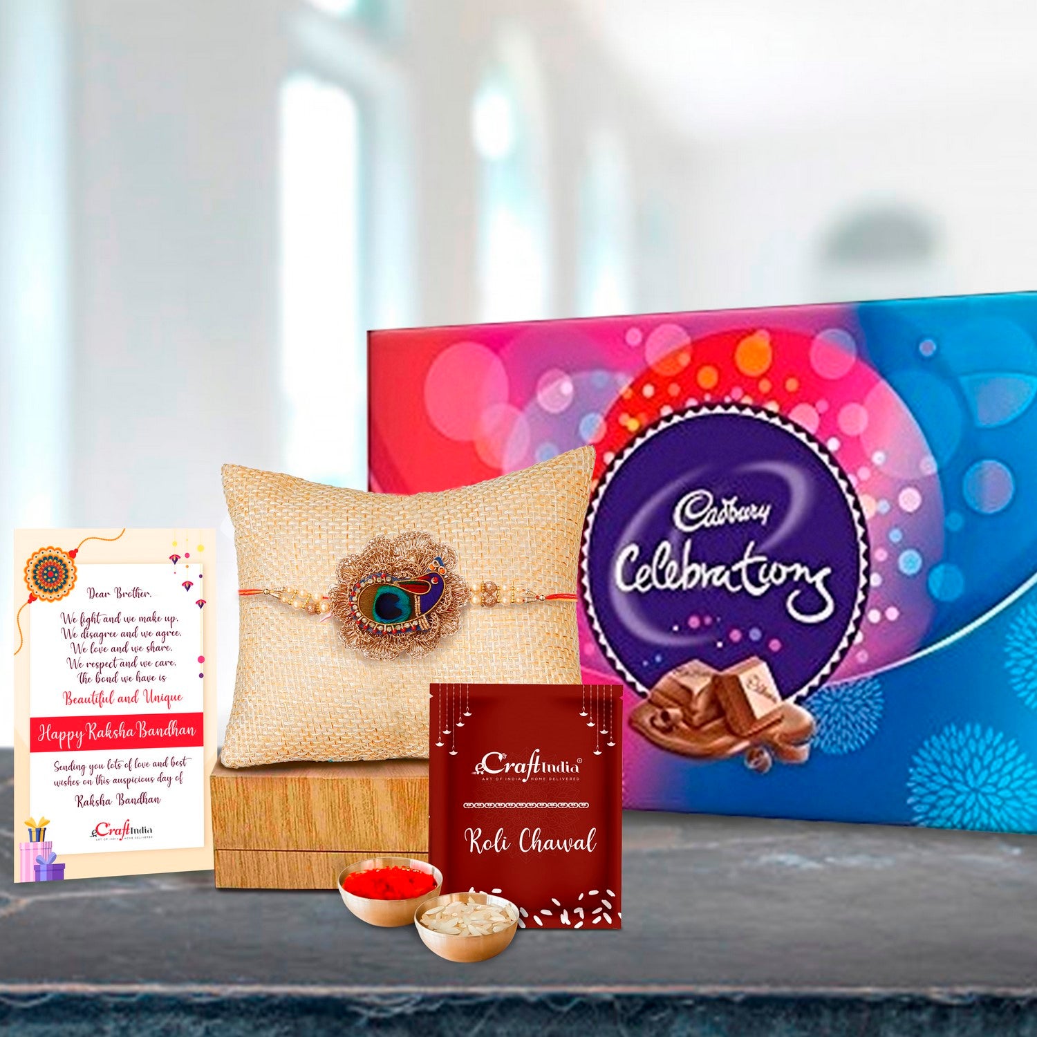 Designer Peacock Rakhi with Cadbury Celebrations Gift Pack of 7 Assorted Chocolates and Roli Chawal Pack, Best Wishes Greeting Card