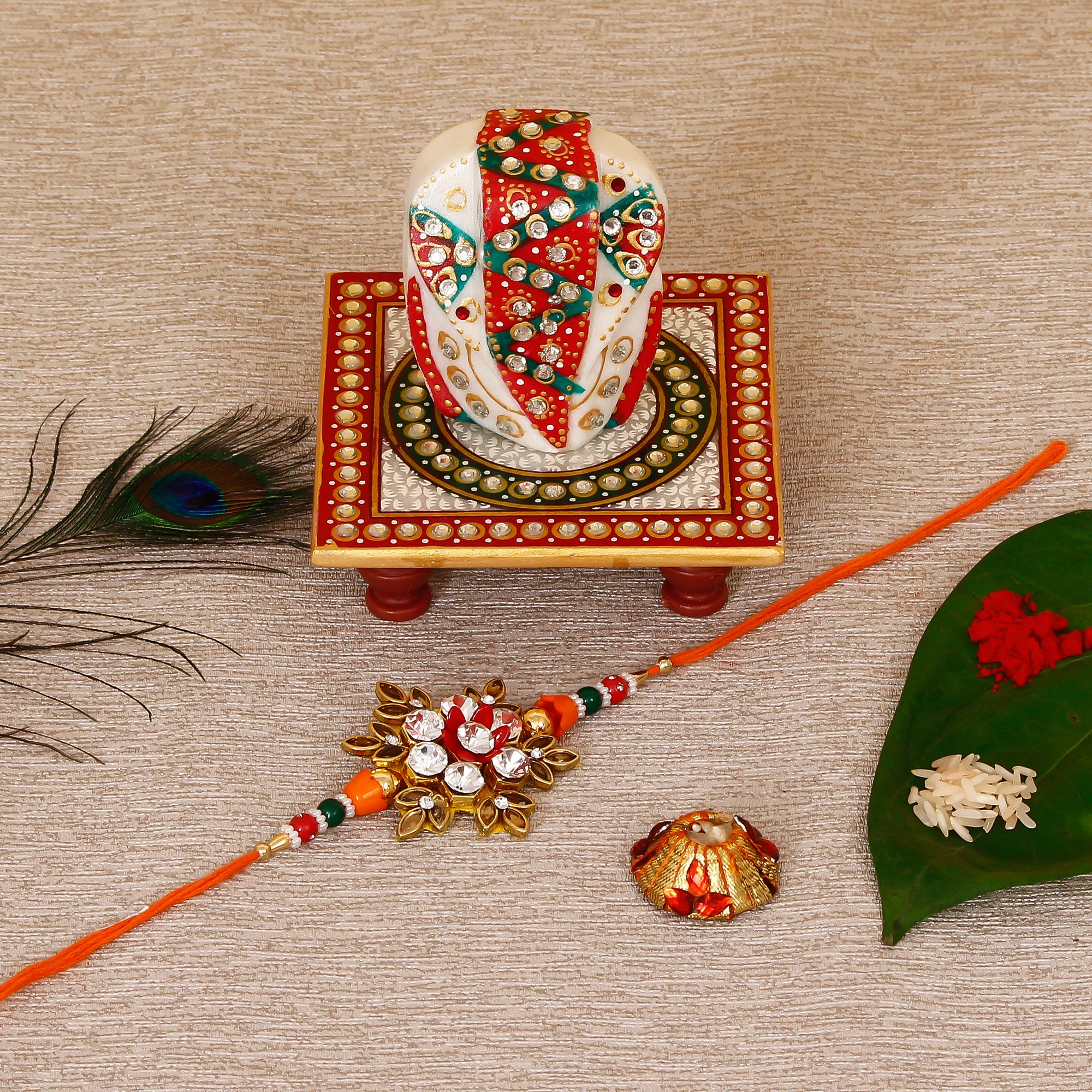 Designer Rakhi with Lord Ganesha on Kundan Studded Marble Chowki and Roli Tikka Matki
