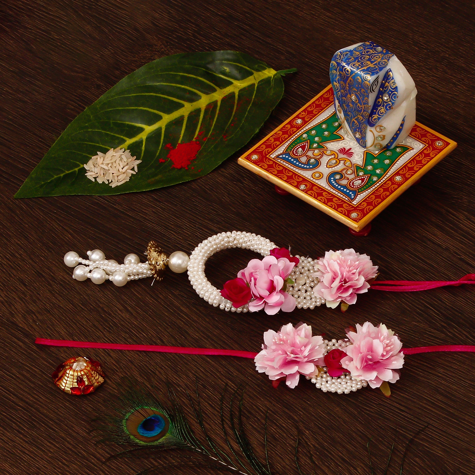 Floral Bhaiya Bhabhi Rakhi with Lord Ganesha on Marble Chowki and Roli Tikka Matki