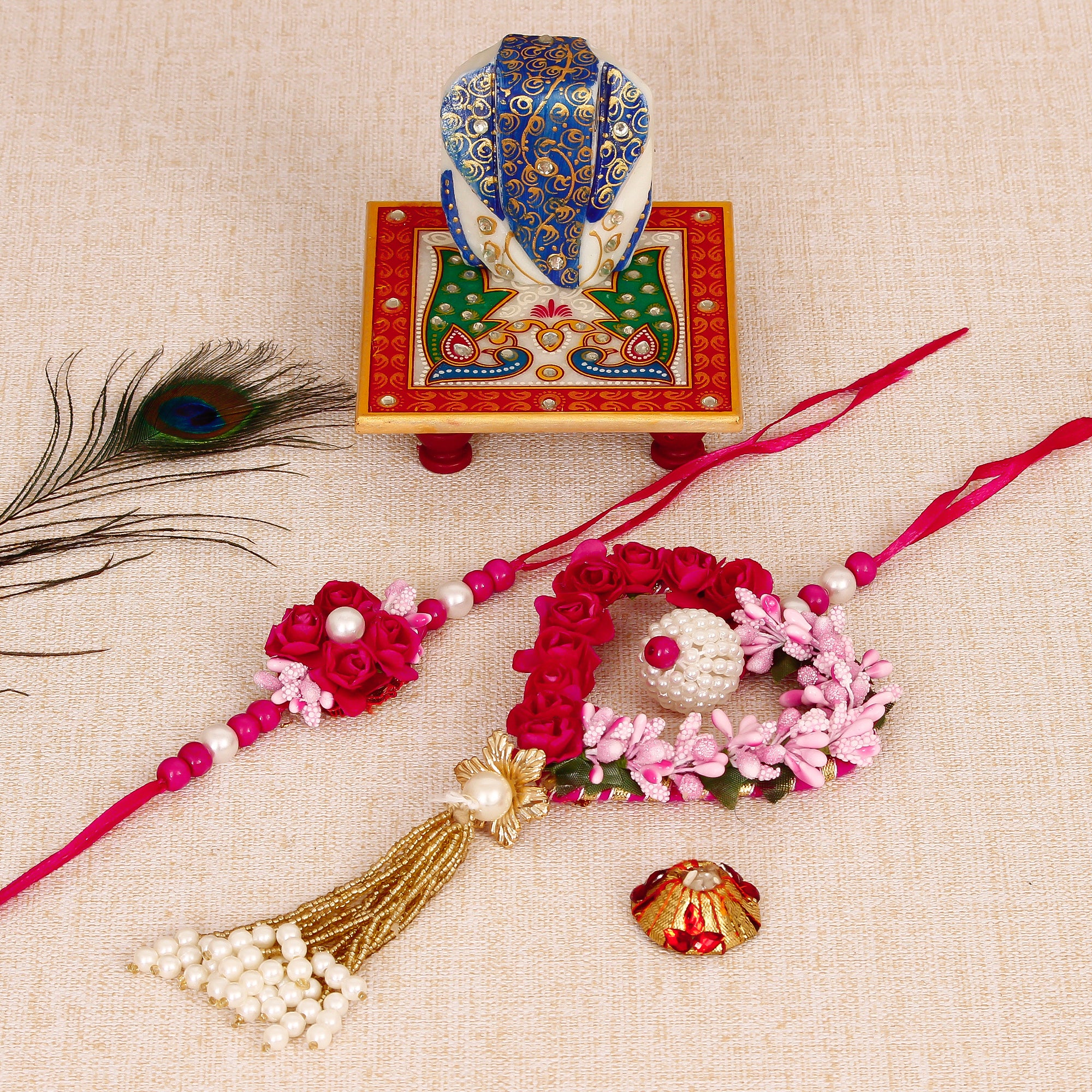 Floral and Heart Shape Bhaiya Bhabhi Rakhi with Lord Ganesha on Marble Chowki and Roli Tikka Matki