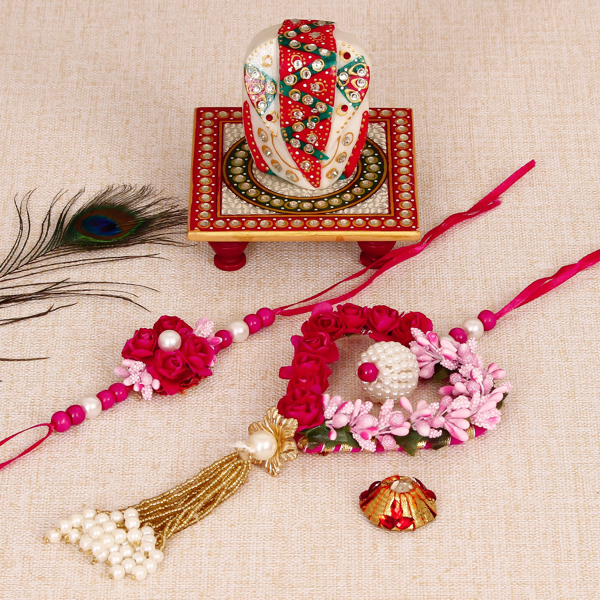 Floral and Heart Shape Bhaiya Bhabhi Rakhi with Lord Ganesha on Kundan Studded Marble Chowki and Roli Tikka Matki