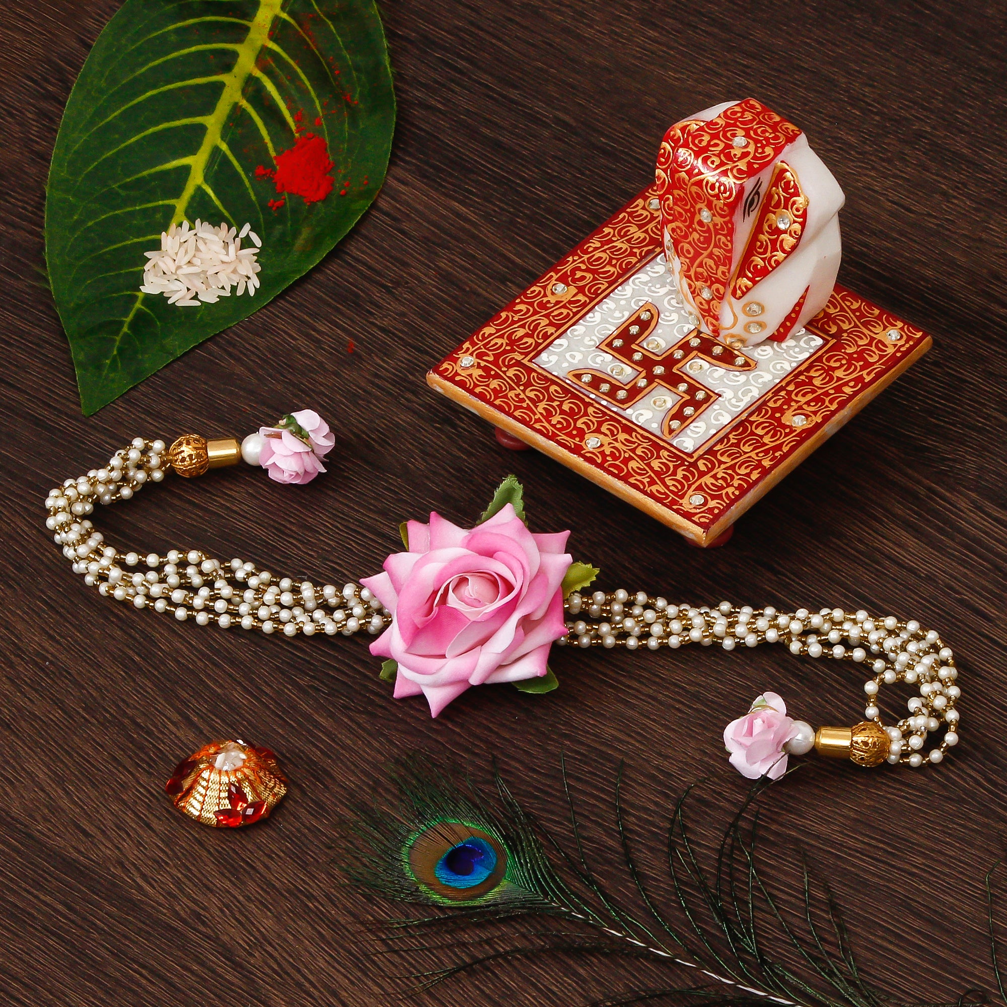 Floral Rakhi for Bhabhi with Ridhi Sidhi Marble chowki and Roli Tikka Matki