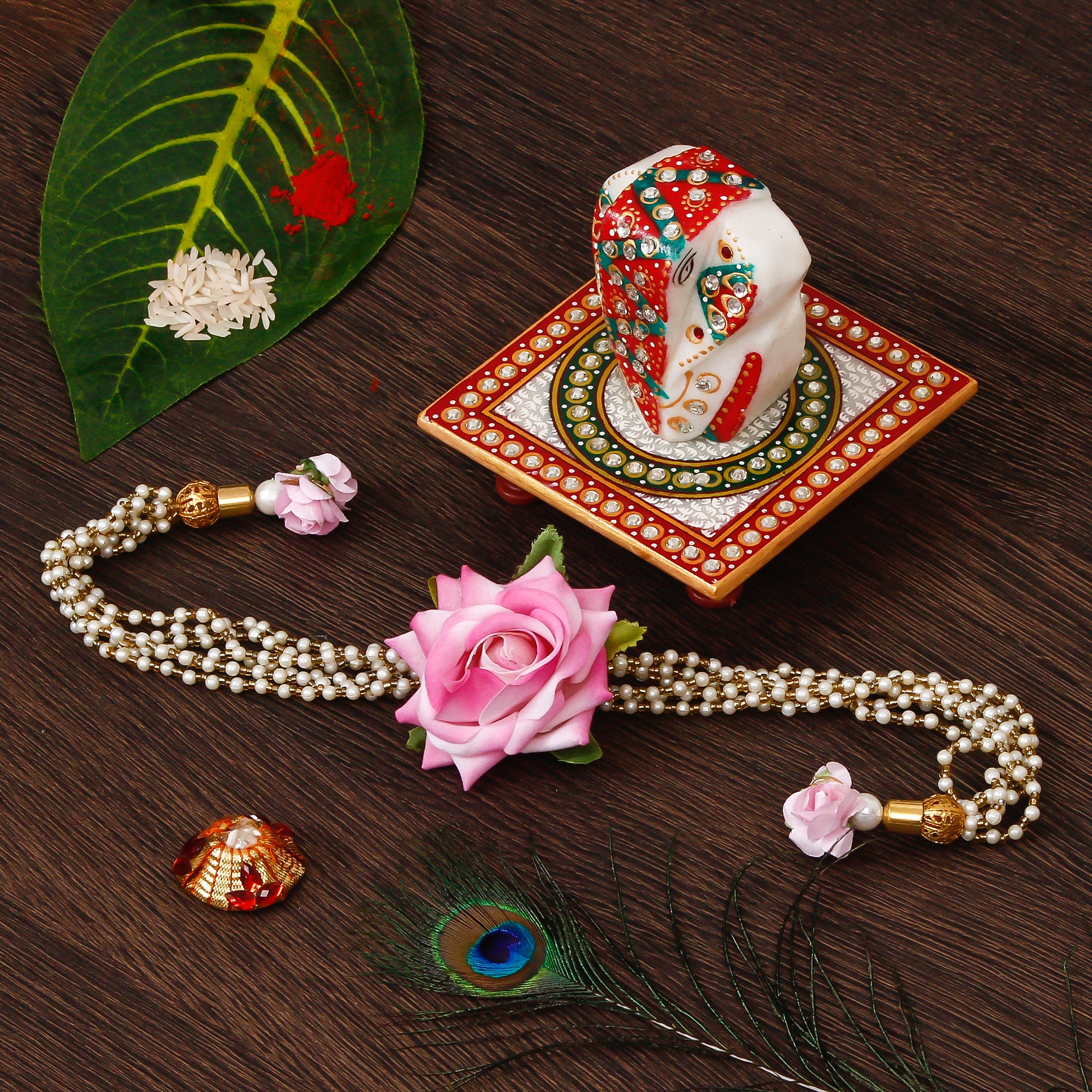 Floral Rakhi for Bhabhi with Lord Ganesha on Kundan Studded Marble Chowki and Roli Tikka Matki
