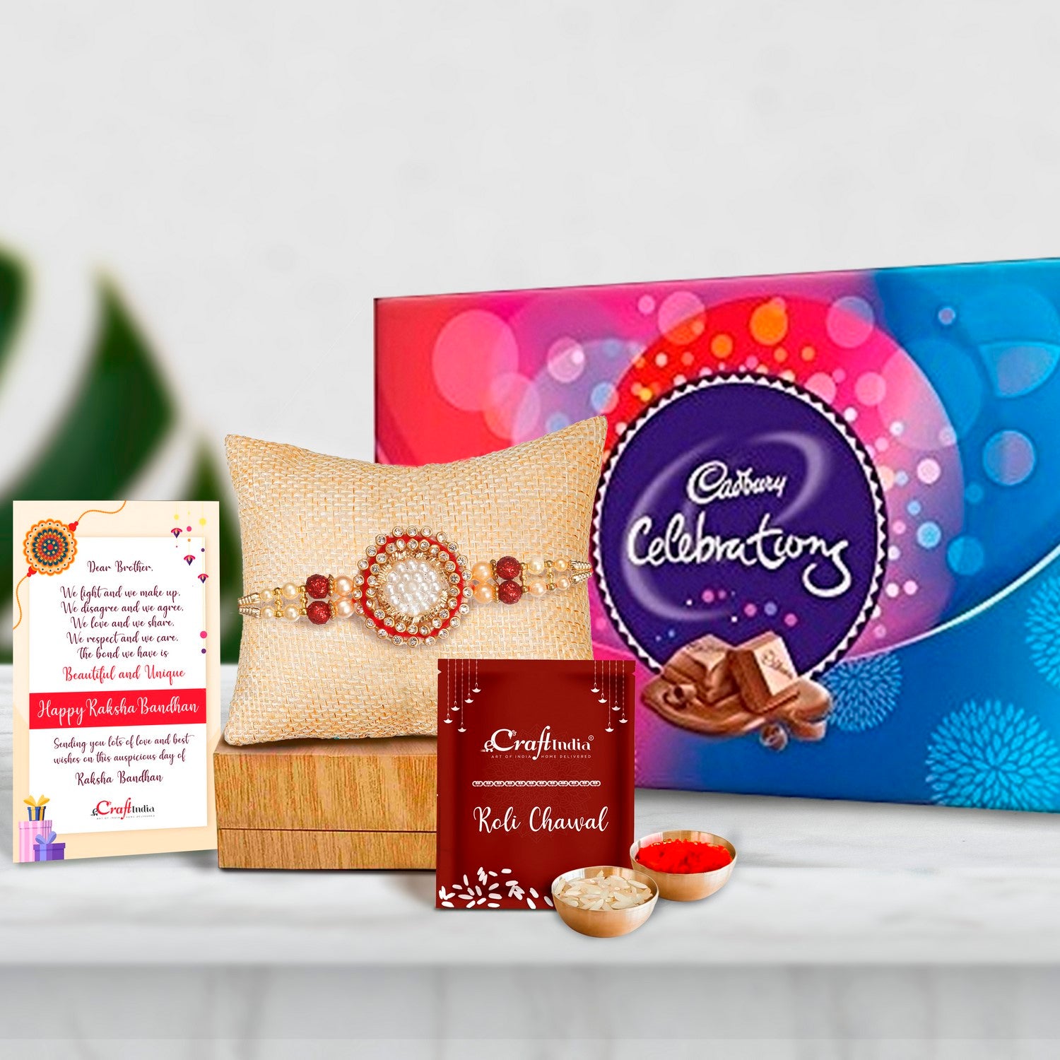Designer Pearl Rakhi with Cadbury Celebrations Gift Pack of 7 Assorted Chocolates and Roli Chawal Pack, Best Wishes Greeting Card