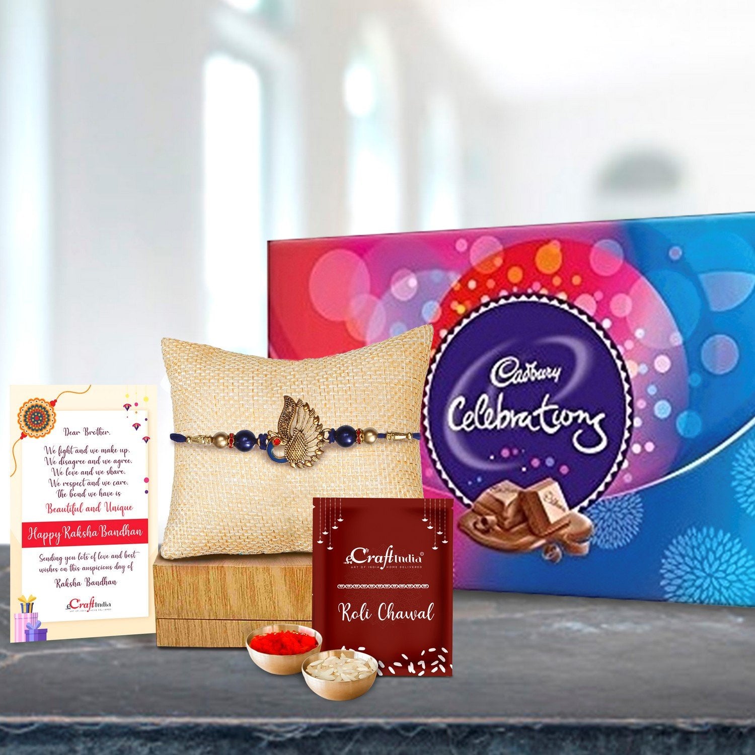 Designer Peacock Rakhi with Cadbury Celebrations Gift Pack of 7 Assorted Chocolates and Roli Chawal Pack, Best Wishes Greeting Card