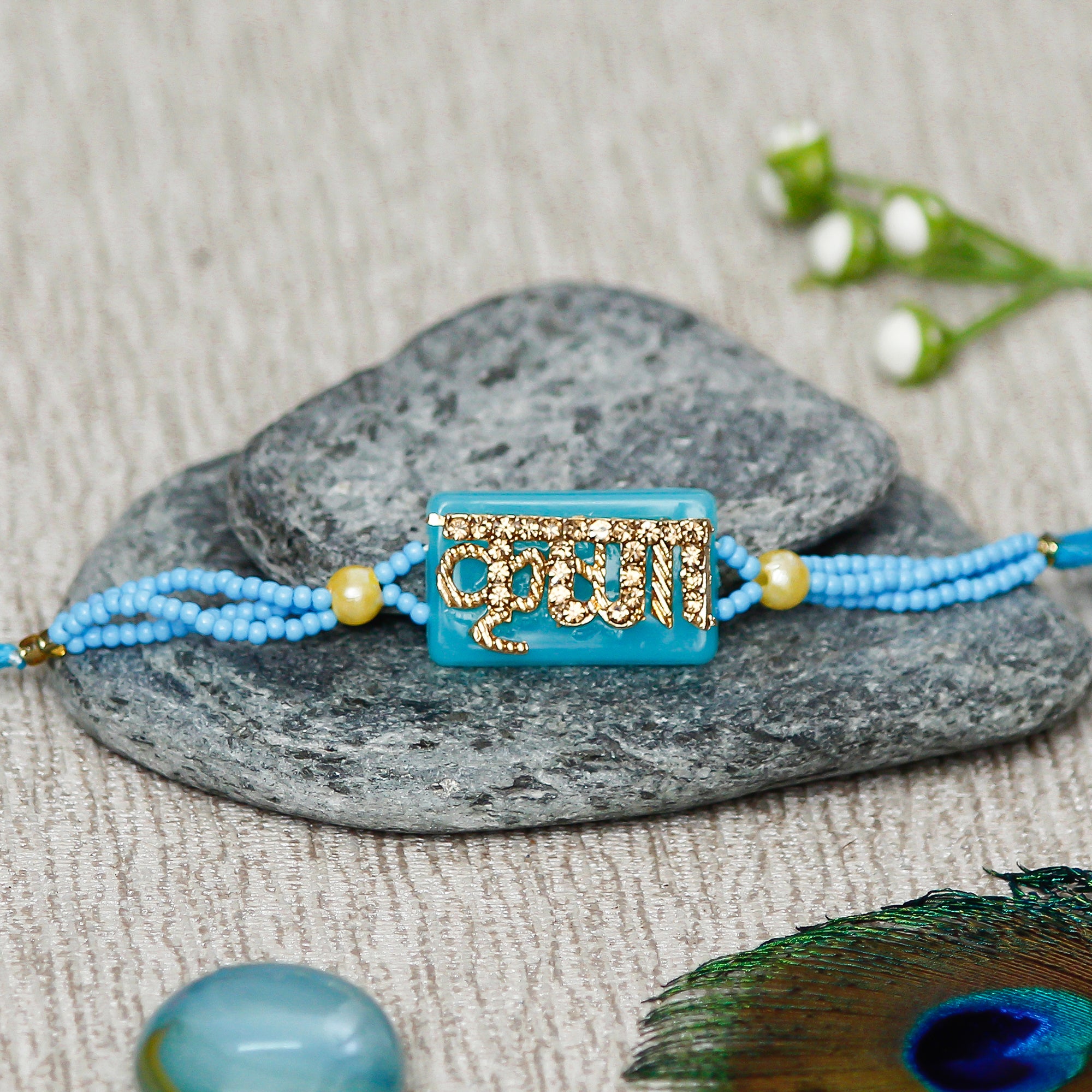 Designer Stone Krishna Rakhi with Handcrafted Ganesha Showpiece and Roli Chawal Pack 1